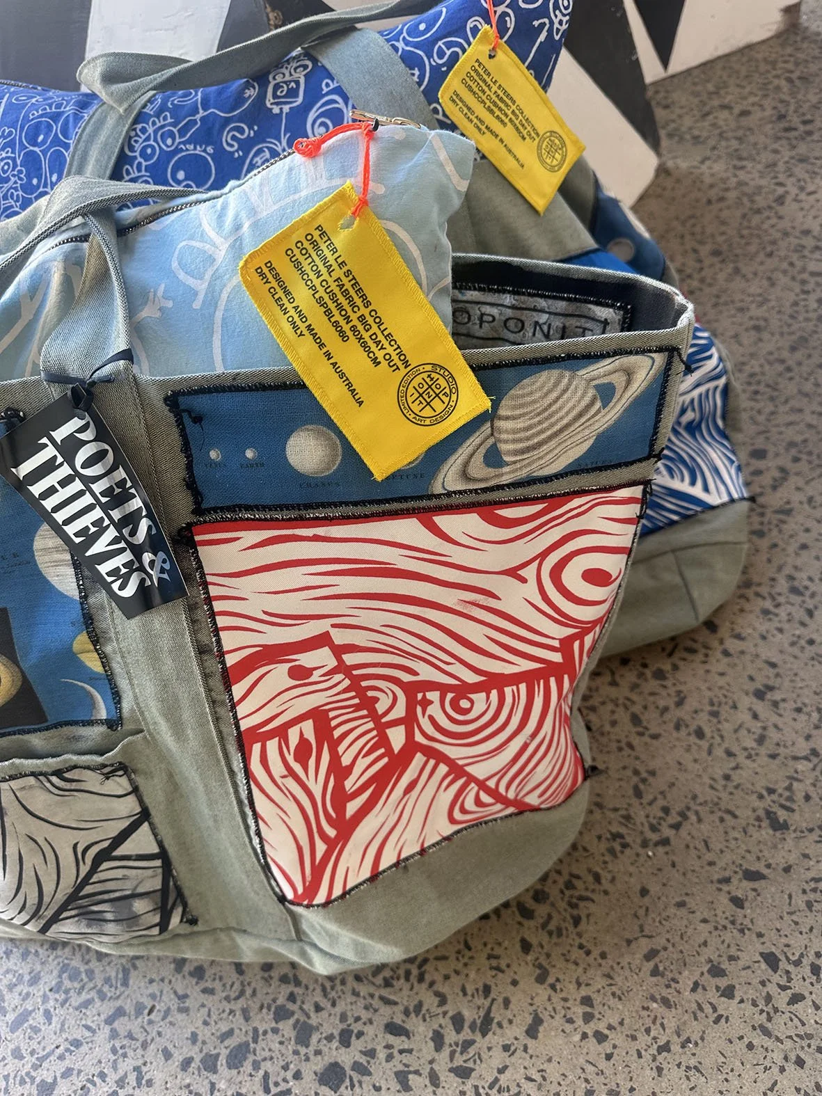 Zoomed in picture of a detail of the oversized canvas bag with astrology and woodgrain patches.