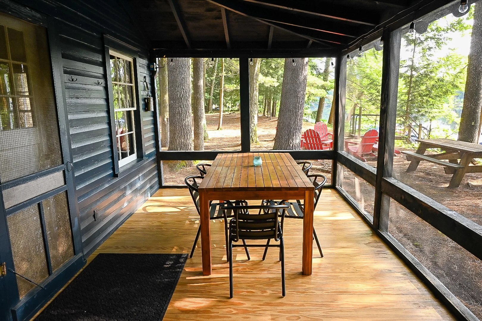 The screened-in-porch has a dining table for six.