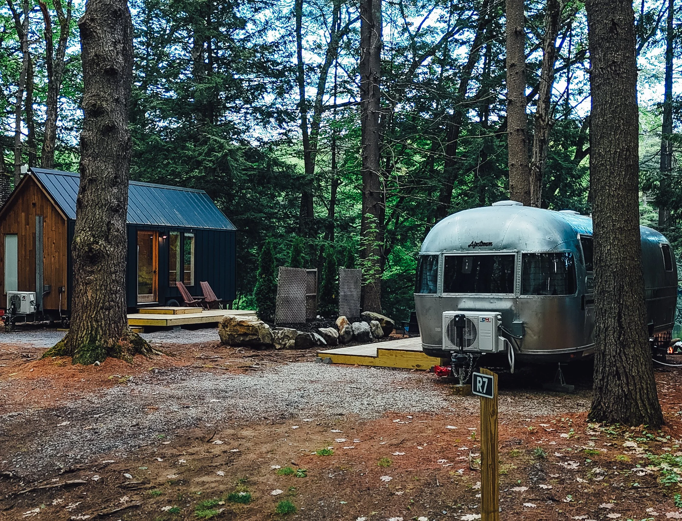 The Acorn and Airstream share a yard by the waterfront.