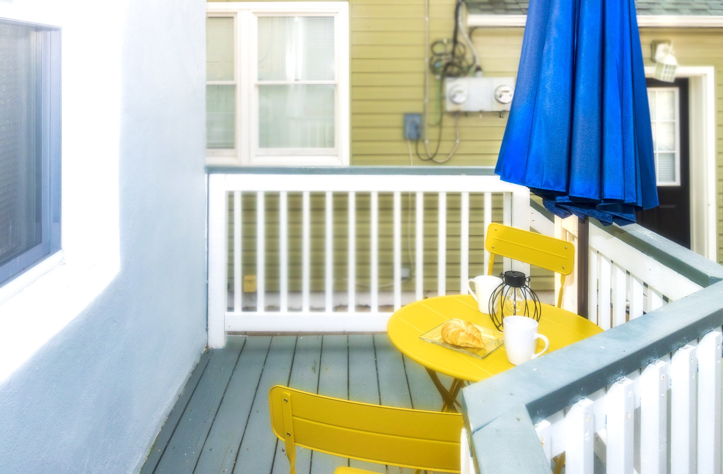 1st floor patio area, yellow bistro set,