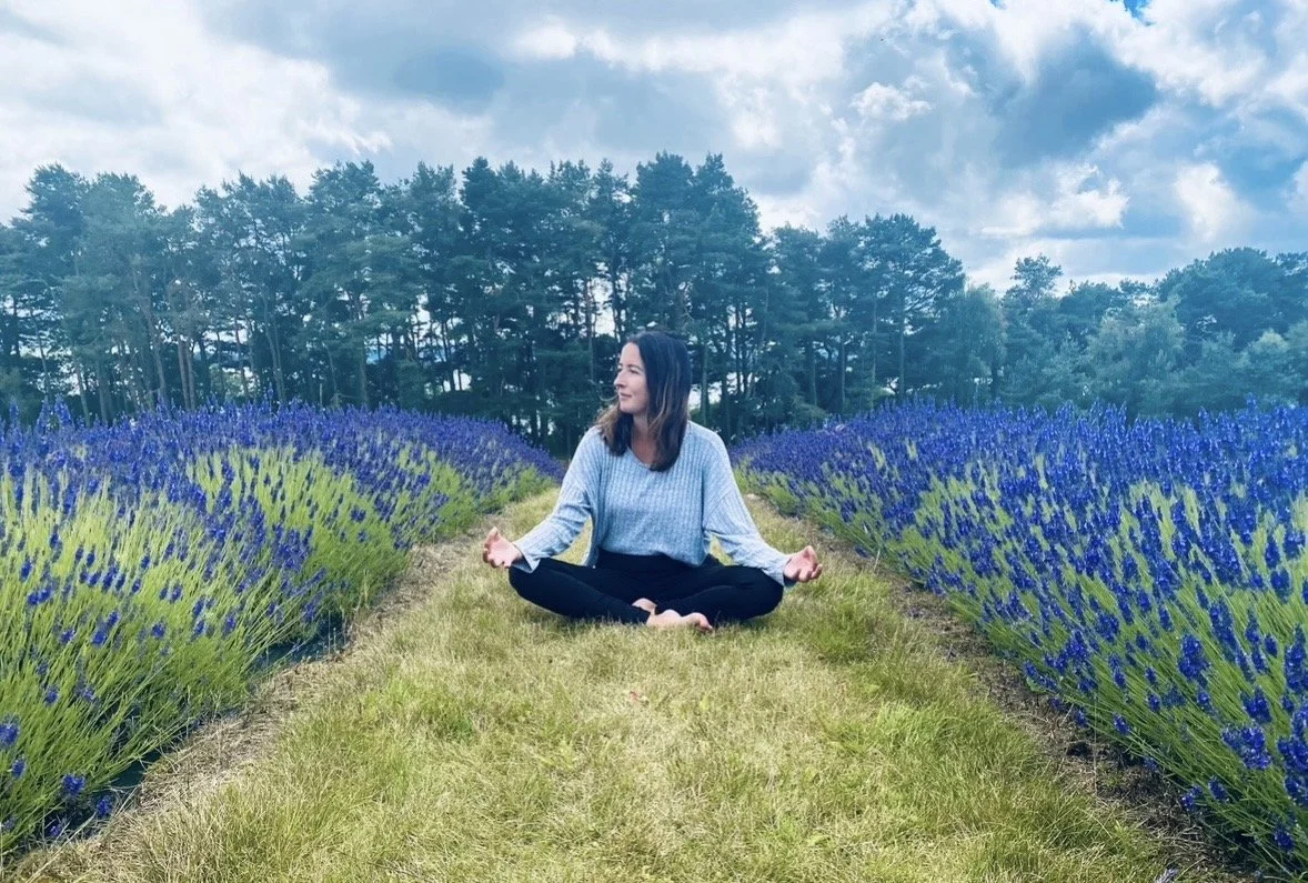 Sam meditating among lavender flowers