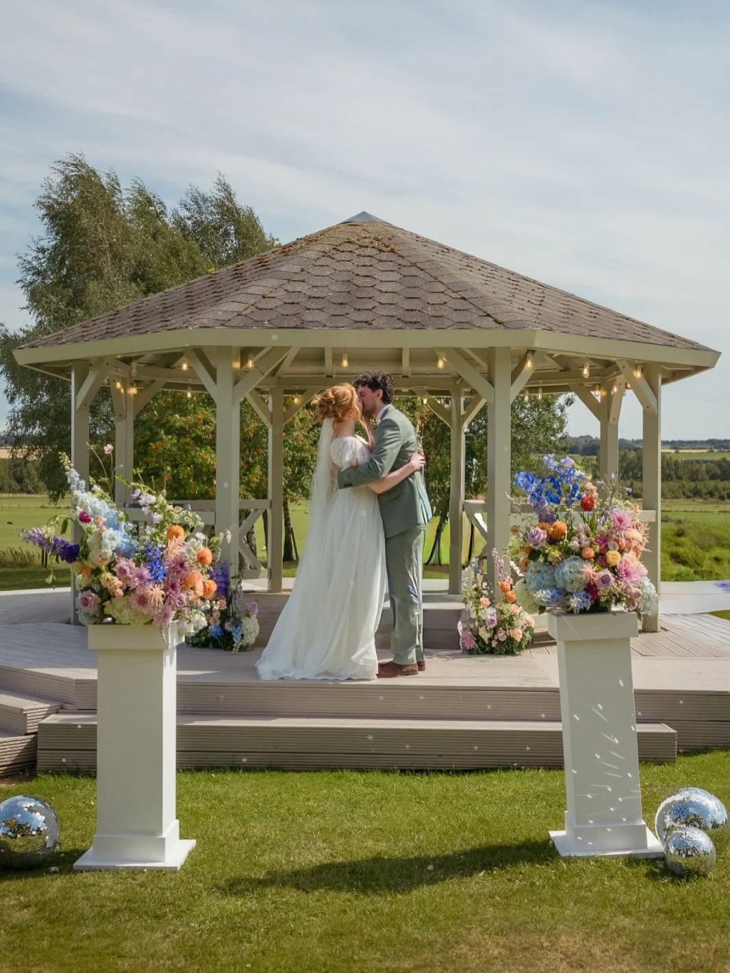 From the moment K &amp; D told us about their ceremony plans filled with bright florals, disco balls and flowing colourful ribbons, we were so excited to see it all come together and wow, did they deliver. 

Our little ceremony spot by the pond was t