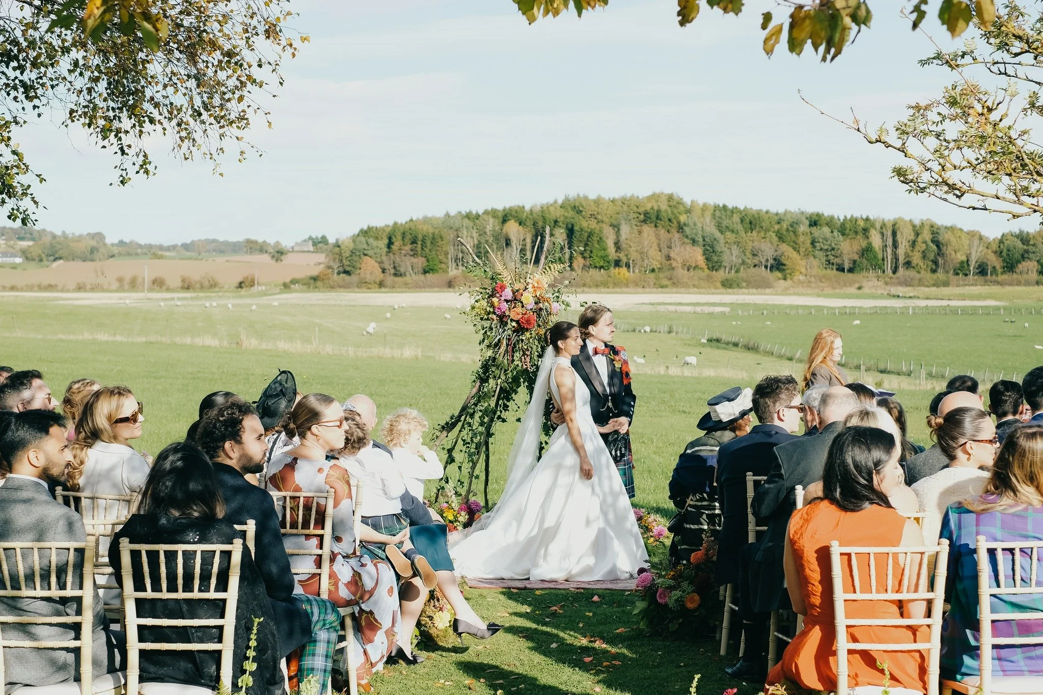 Outdoor ceremonies at Bachilton 💗🧡

E&amp;K's outdoor ceremony set for 80 last October had the fields stretching out behind them and the forests sat quietly in the background. Add those pops of pink and orange in the ceremony florals by @michelle__
