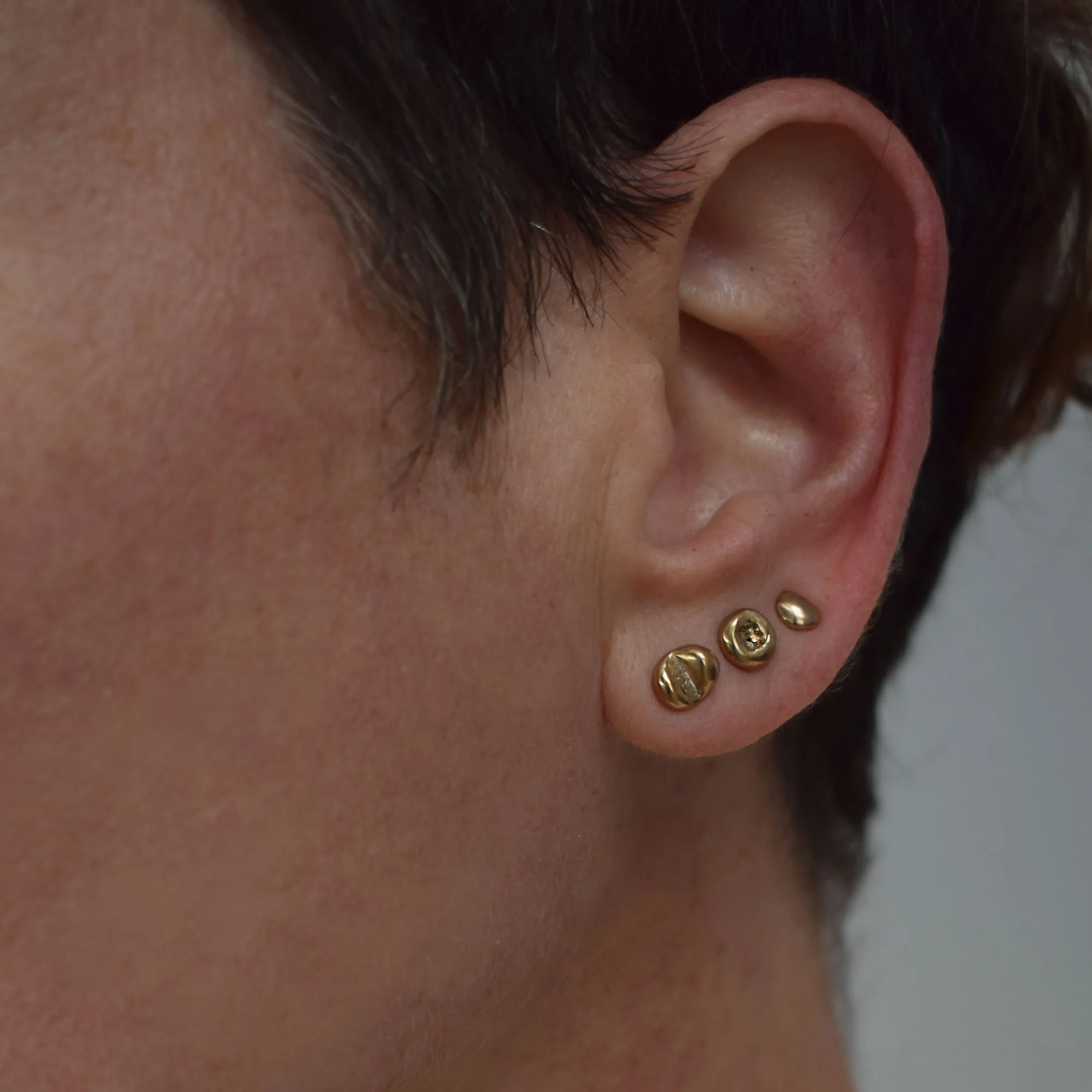 Minimalist asymmetrical bronze stud earrings combo, a set of 5, with an abstract organic aesthetic. Sustainably handmade using the silver granulation technique in our jewelry workshop.