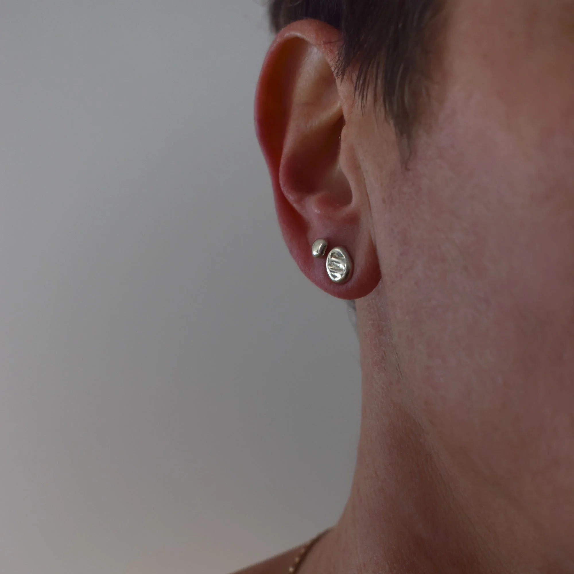 Freeform molten silver stud earrings combo with mismatched irregular shapes and textures from solid sterling silver 925. Ethically handmade in a small jewelry studio in Greece.