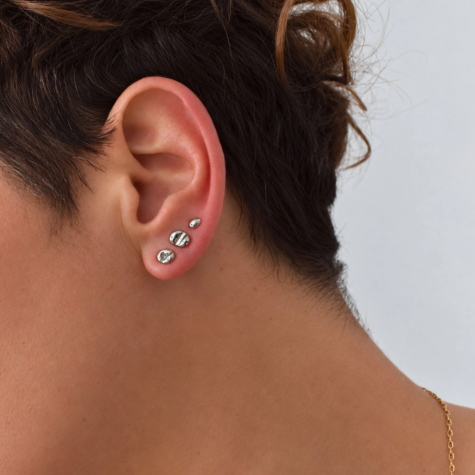 A set of dainty molten sterling silver 925 stud earrings perfect for ear stacks. Hand-fabricated and eco-friendly as they are made from recycling our jewelry silver scraps from other designs.