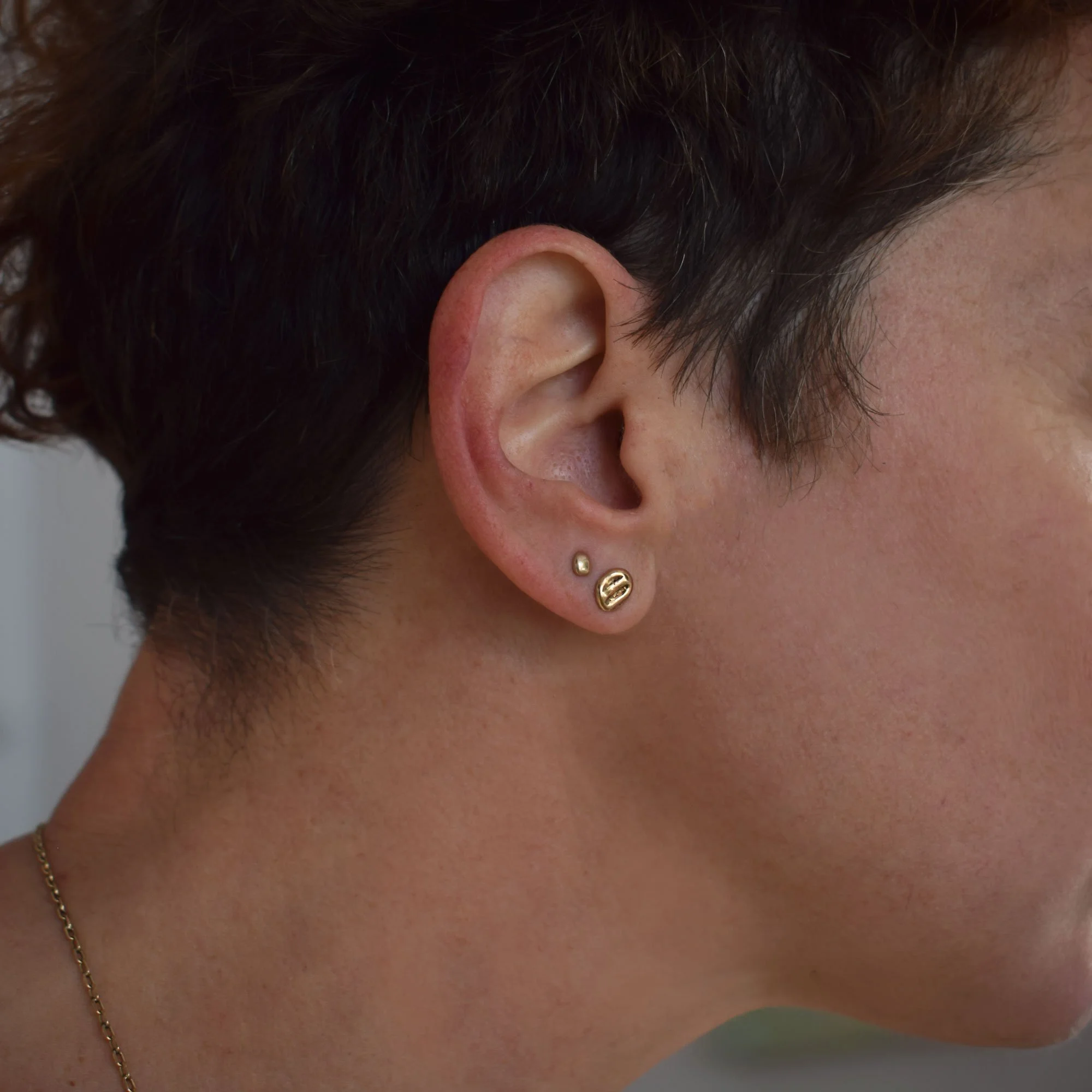 A set of dainty molten bronze stud earrings perfect for ear stacks. Hand-fabricated and eco-friendly as they are made from recycling our metal scraps from other designs.