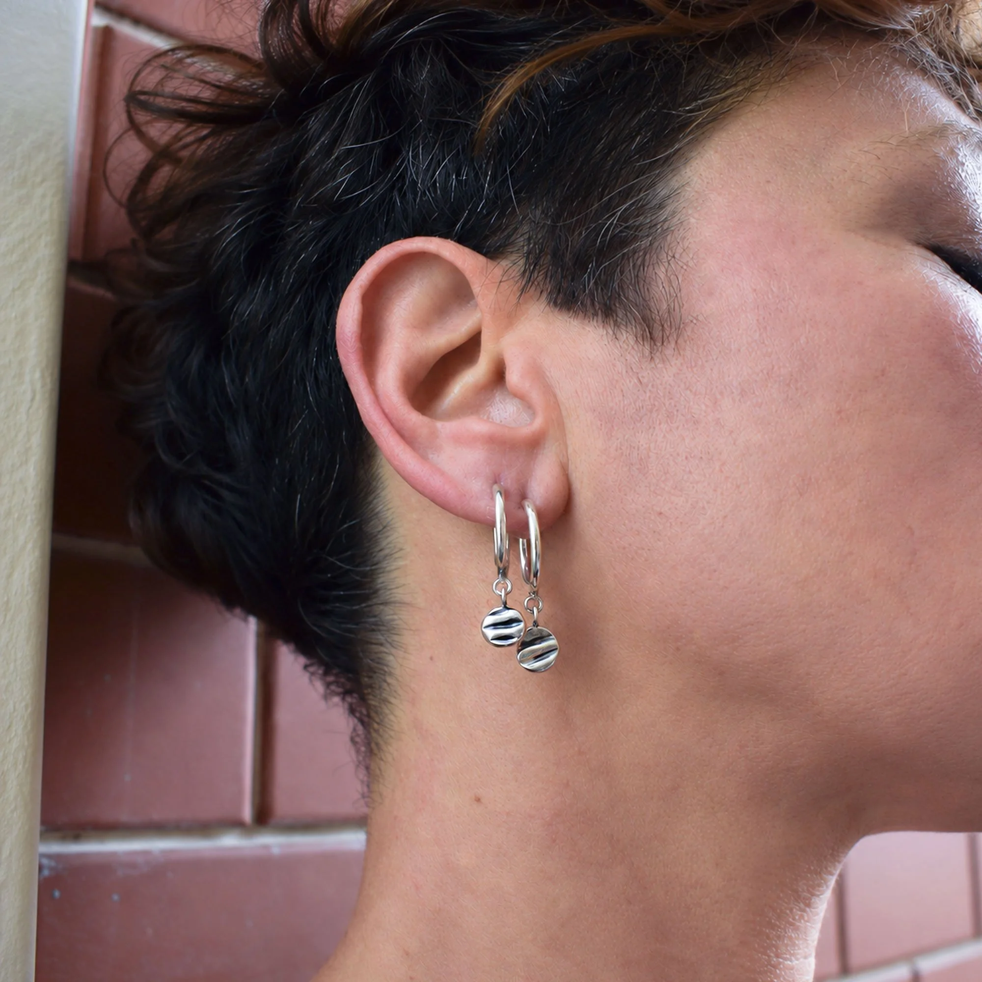 Handmade sterling silver 925 hoop earrings inspired by the sea. with organic shell-imprinted charms