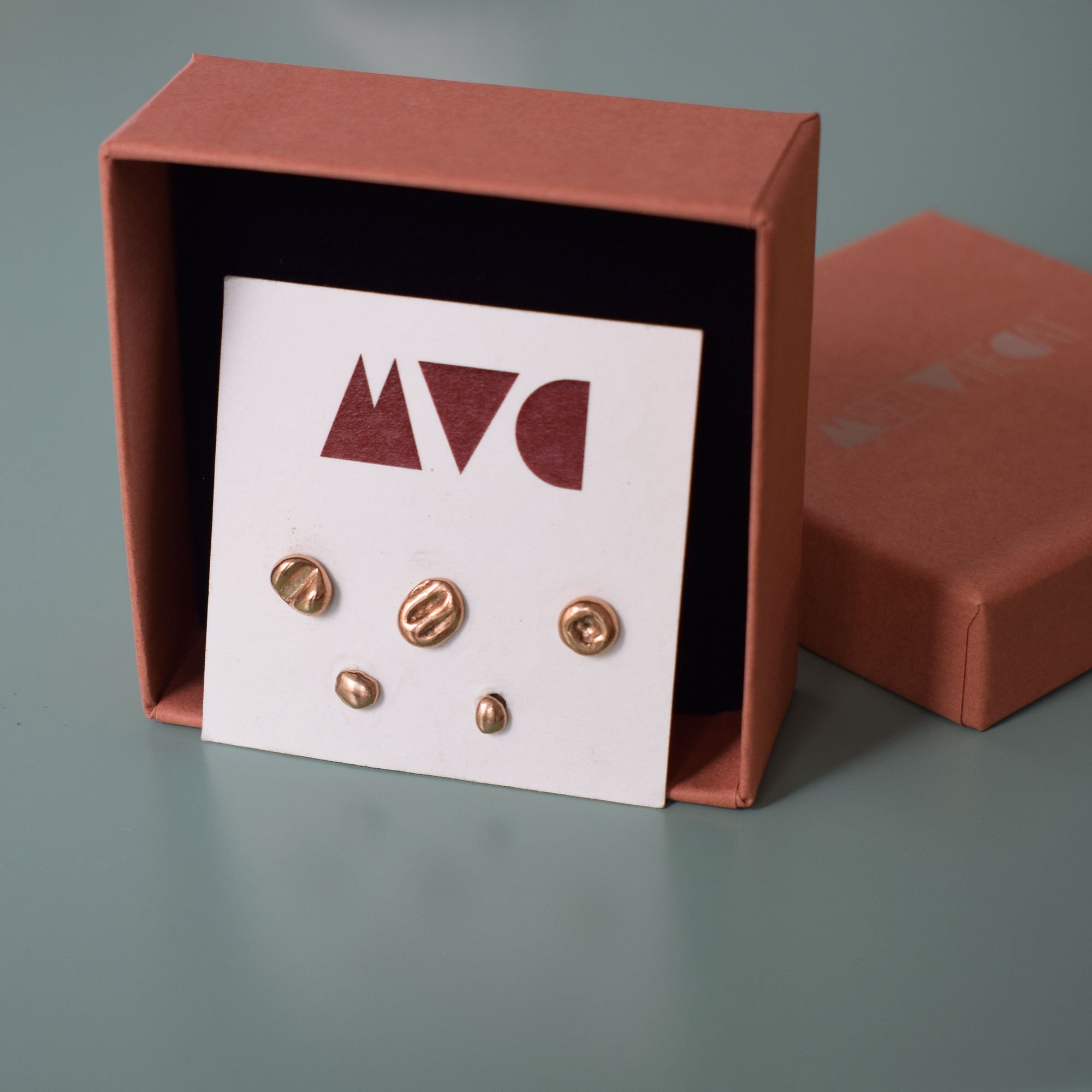 Minimalist, dainty studs set of 5, with imprint textures, sustainable handmade by melting our bronze scraps from other designs, creating free form organic shapes so each stud is unique.