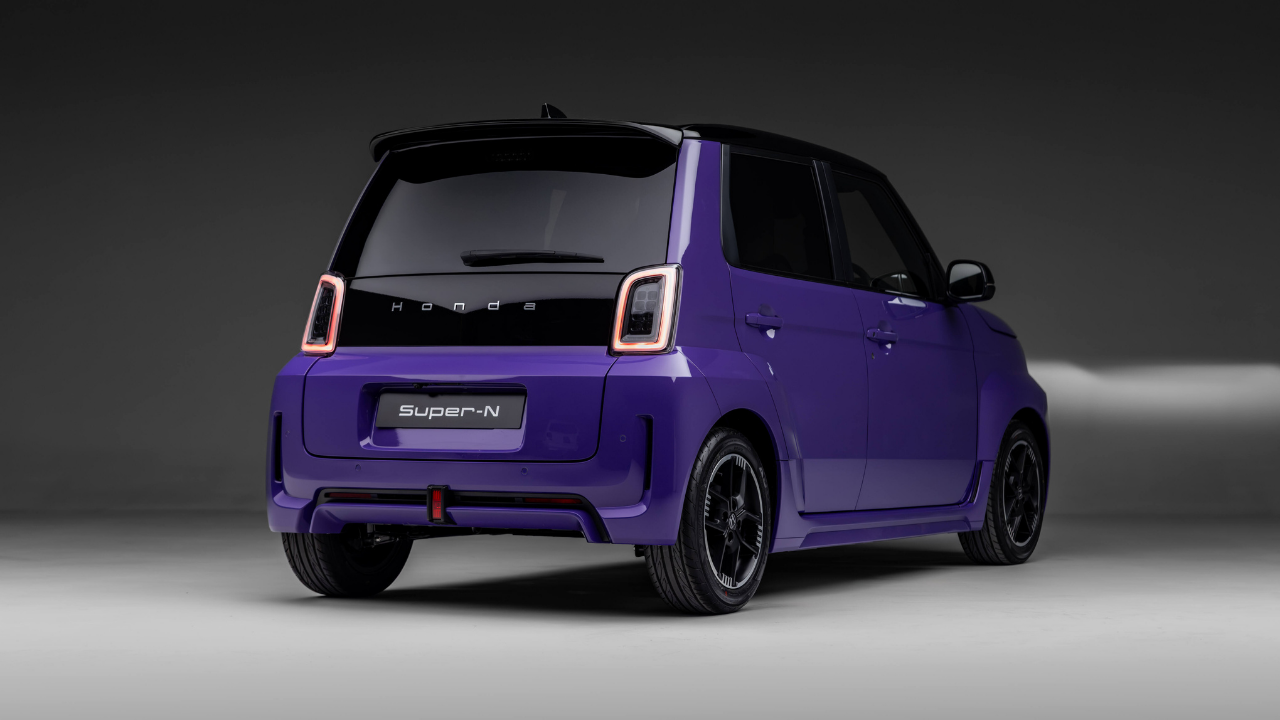 Rendering of the rear of a purple Honda Super-N electric car with glowing taillights in a gray studio.