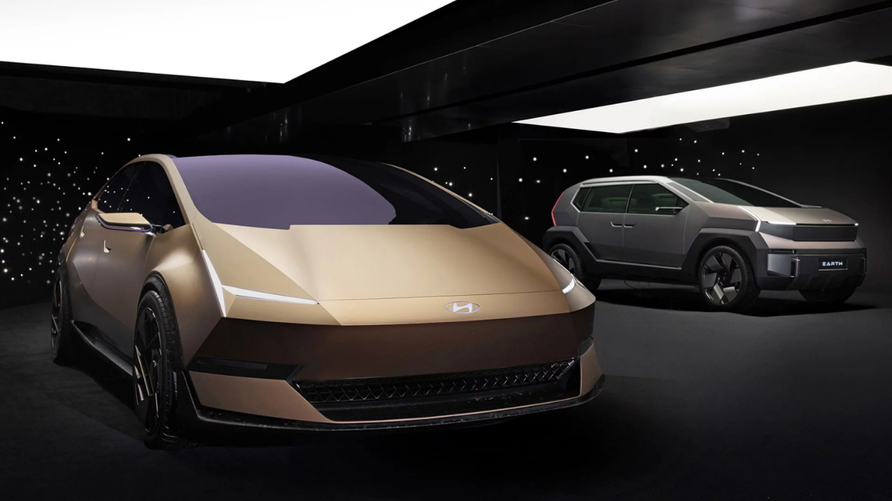 Rendering of gold Hyundai Venus and grey Earth SUV concept in a dark starry studio for future EV design trends.