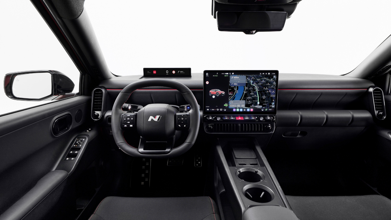 Rendering of red Hyundai Ioniq 3 N interior with digital cockpit and infotainment screen in studio.