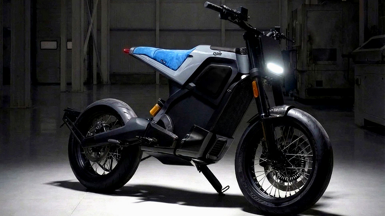 Grey DAB 1alpha electric motorcycle with blue seat in a dark industrial workshop. Futuristic urban mobility.