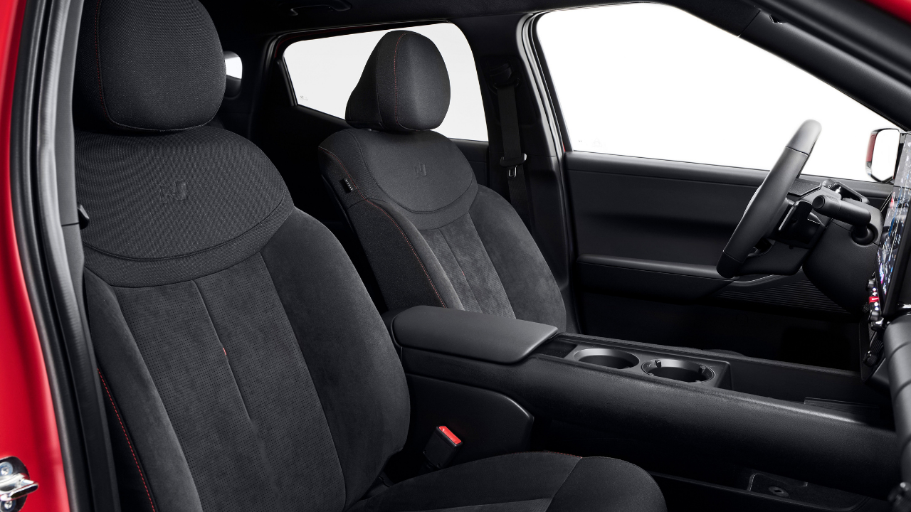 Rendering of black seats with red stitching and N logo inside a red Hyundai Ioniq 3 N performance EV.