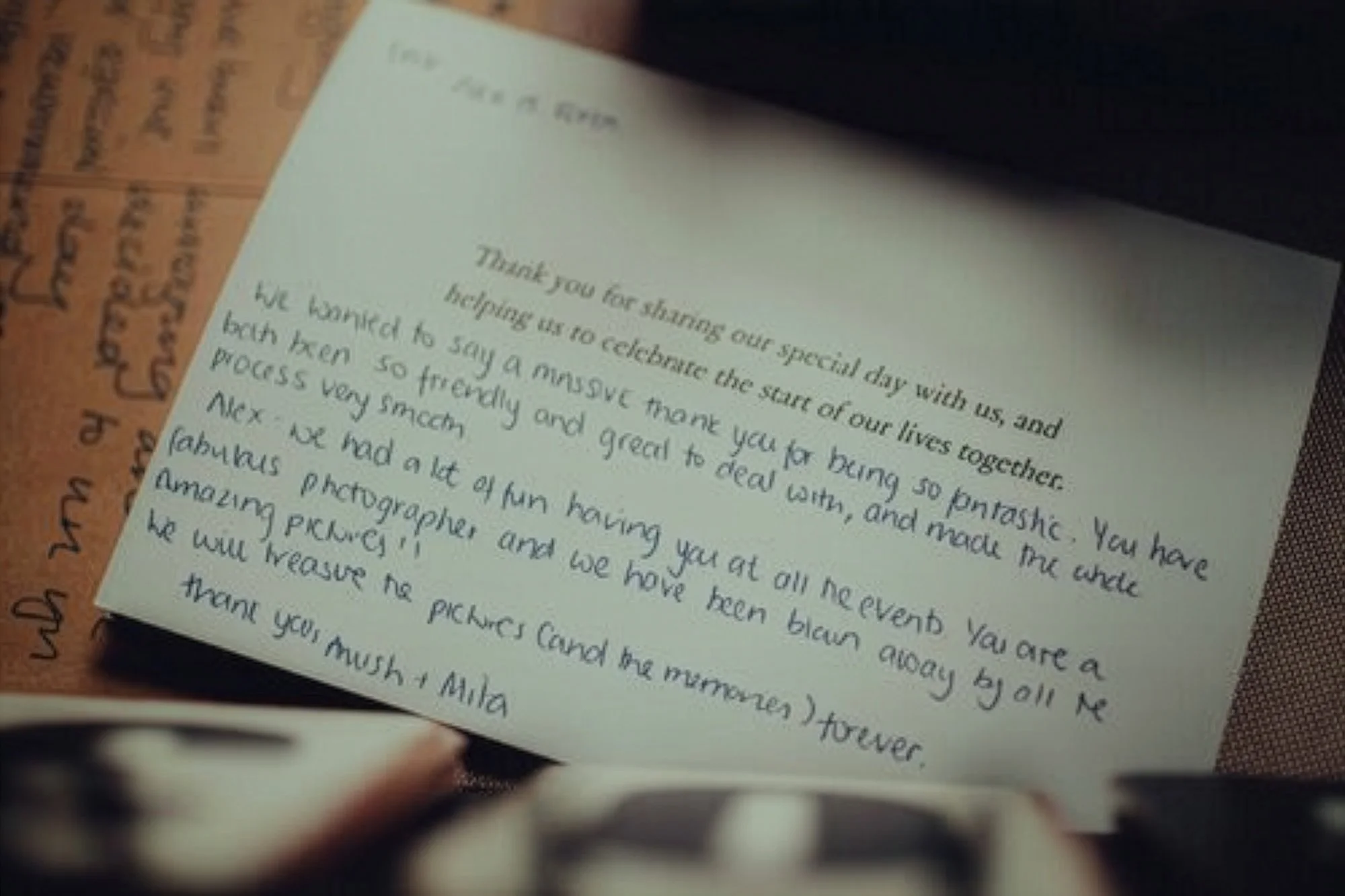 A handwritten thank you note on a white paper expressing gratitude for a fun and memorable day, mentioning a photographer and photos.