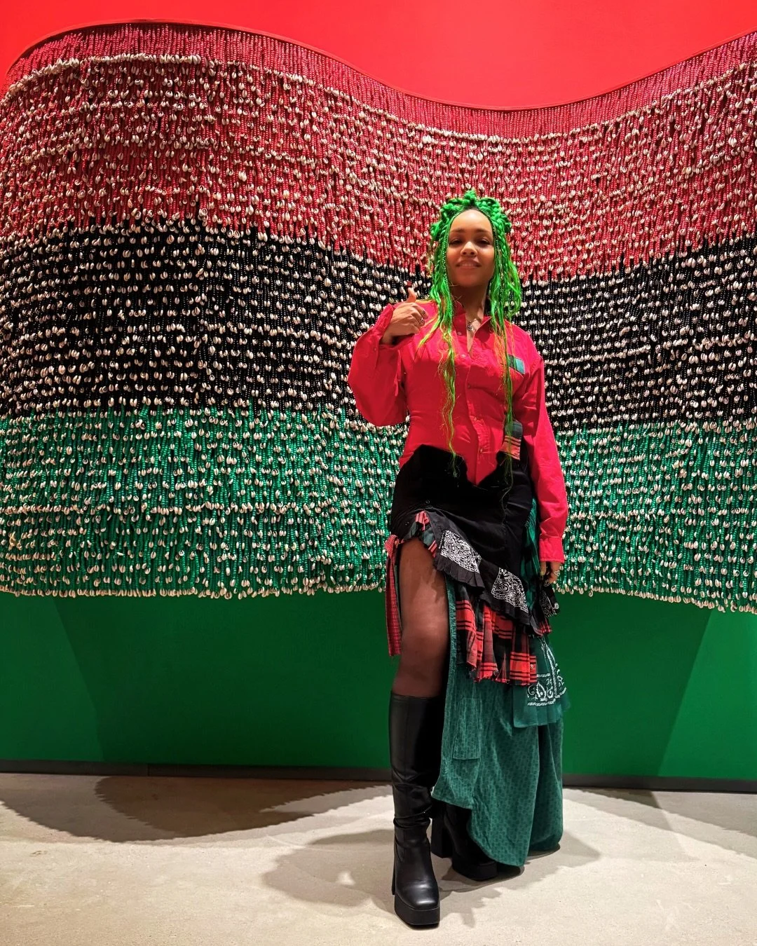 &ldquo;It Takes a Village to Raise a Flag.&rdquo;

In this powerful work, one of many on view, Chicago-based artist Shani Crowe (@crowezilla) transforms thousands of beads and cowrie shells into a tribute to the Pan-African flag, honoring Ujima and c