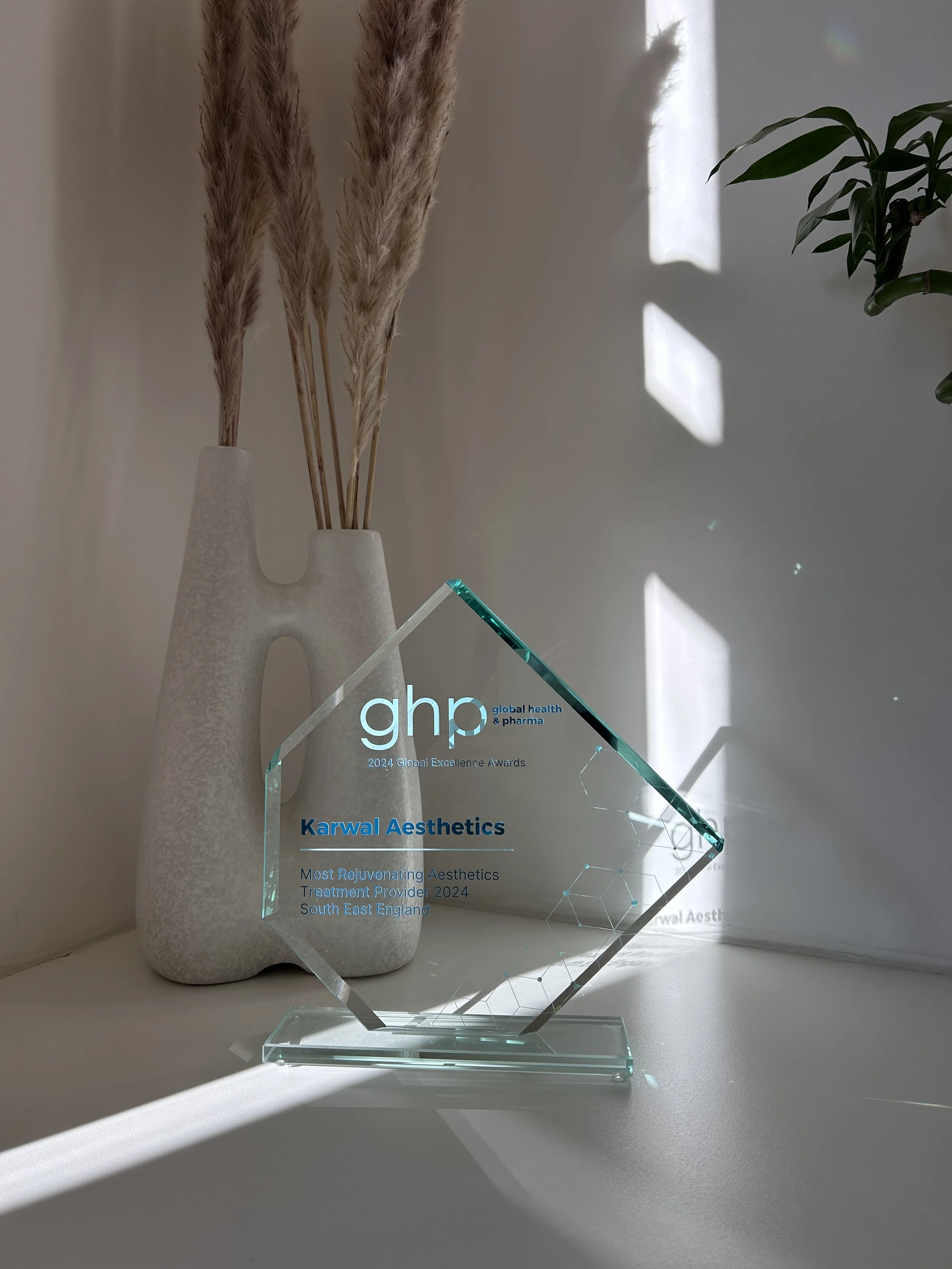 GHP Global Excellence Awards 2024 trophy naming Karwal Aesthetics Most Rejuvenating Aesthetics Treatment Provider, South East England