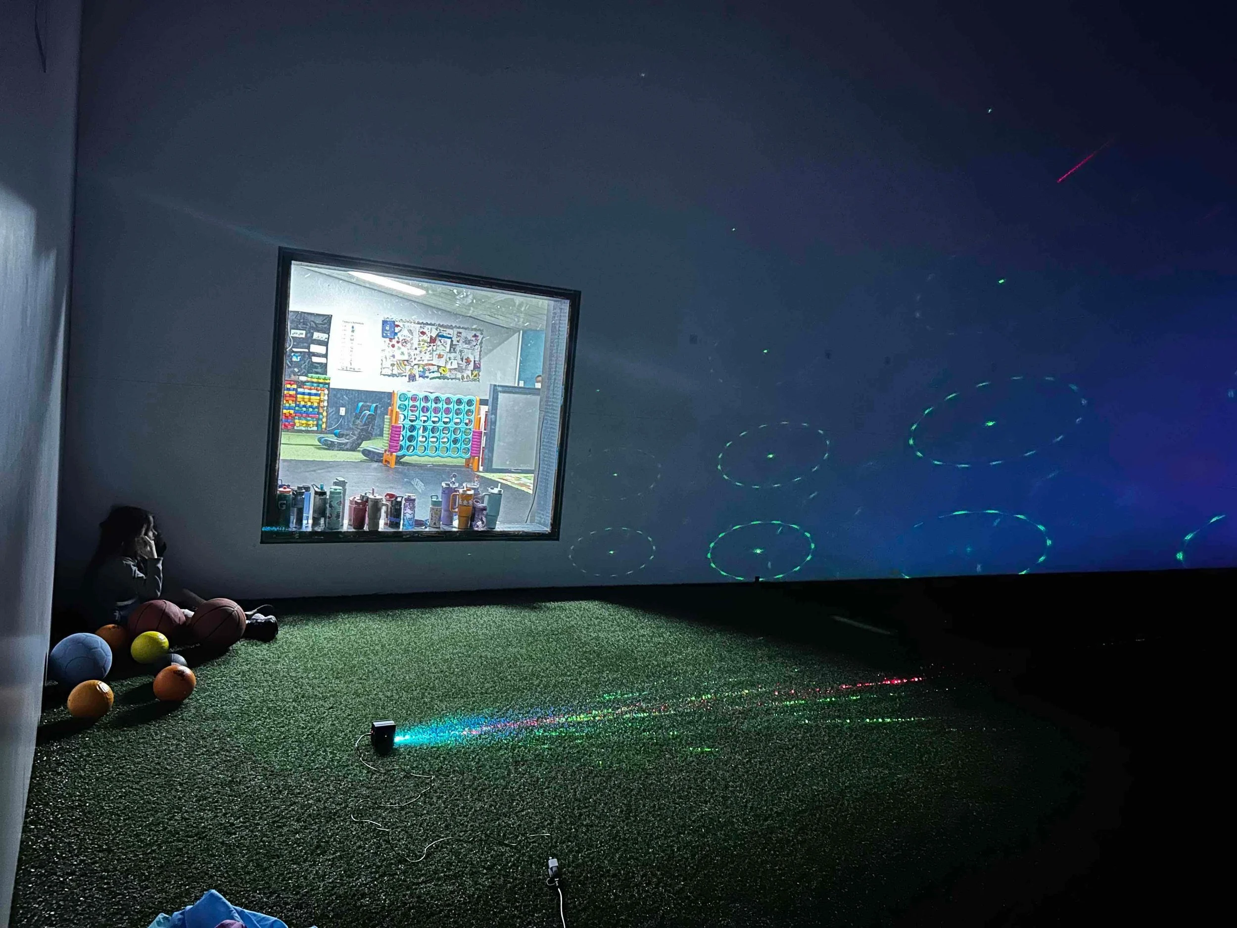 Sensory room with projected visual effects used during pediatric occupational therapy for regulation and sensory processing.