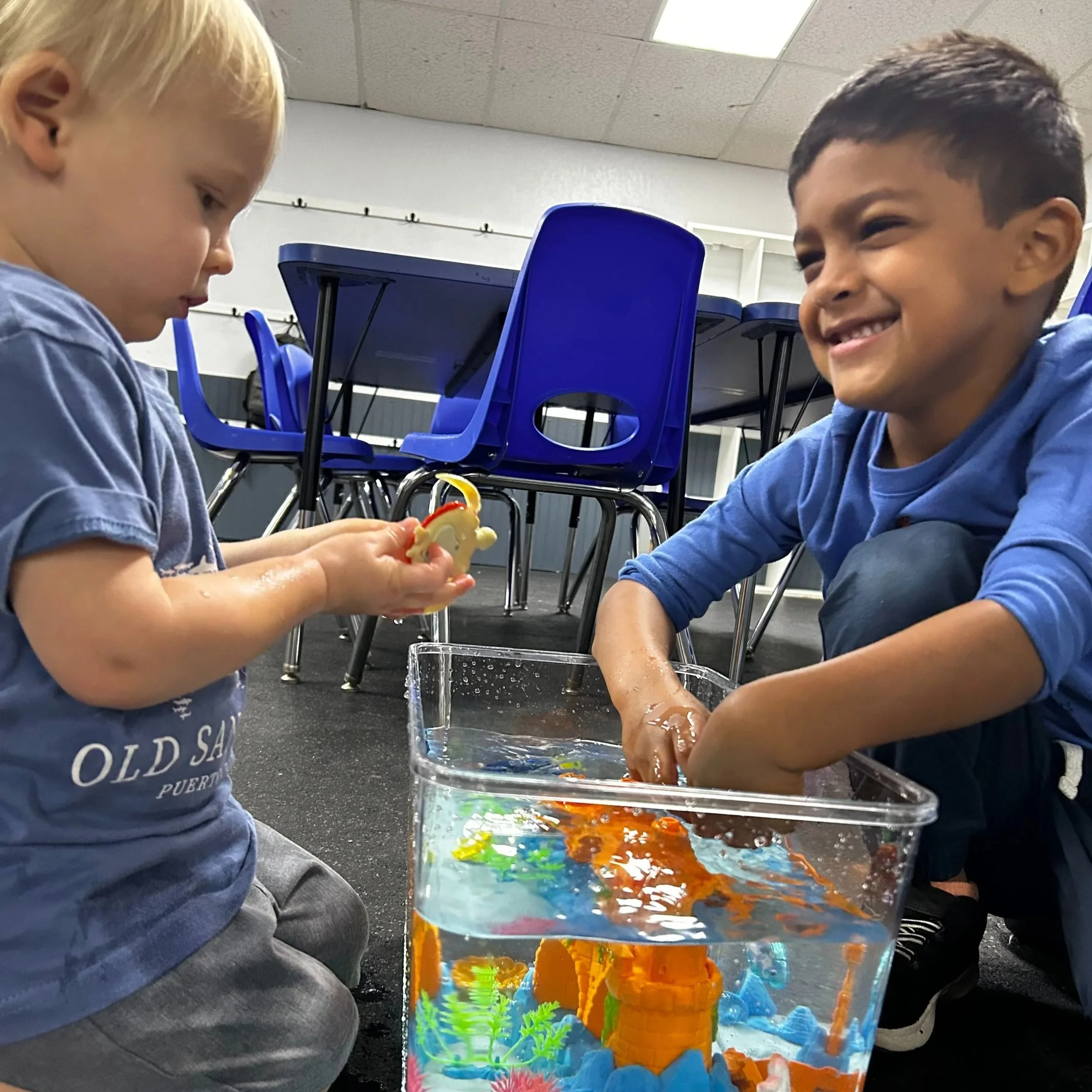 Children engaging together in a sensory play activity during pediatric therapy at Apollo Beach Therapy Center.