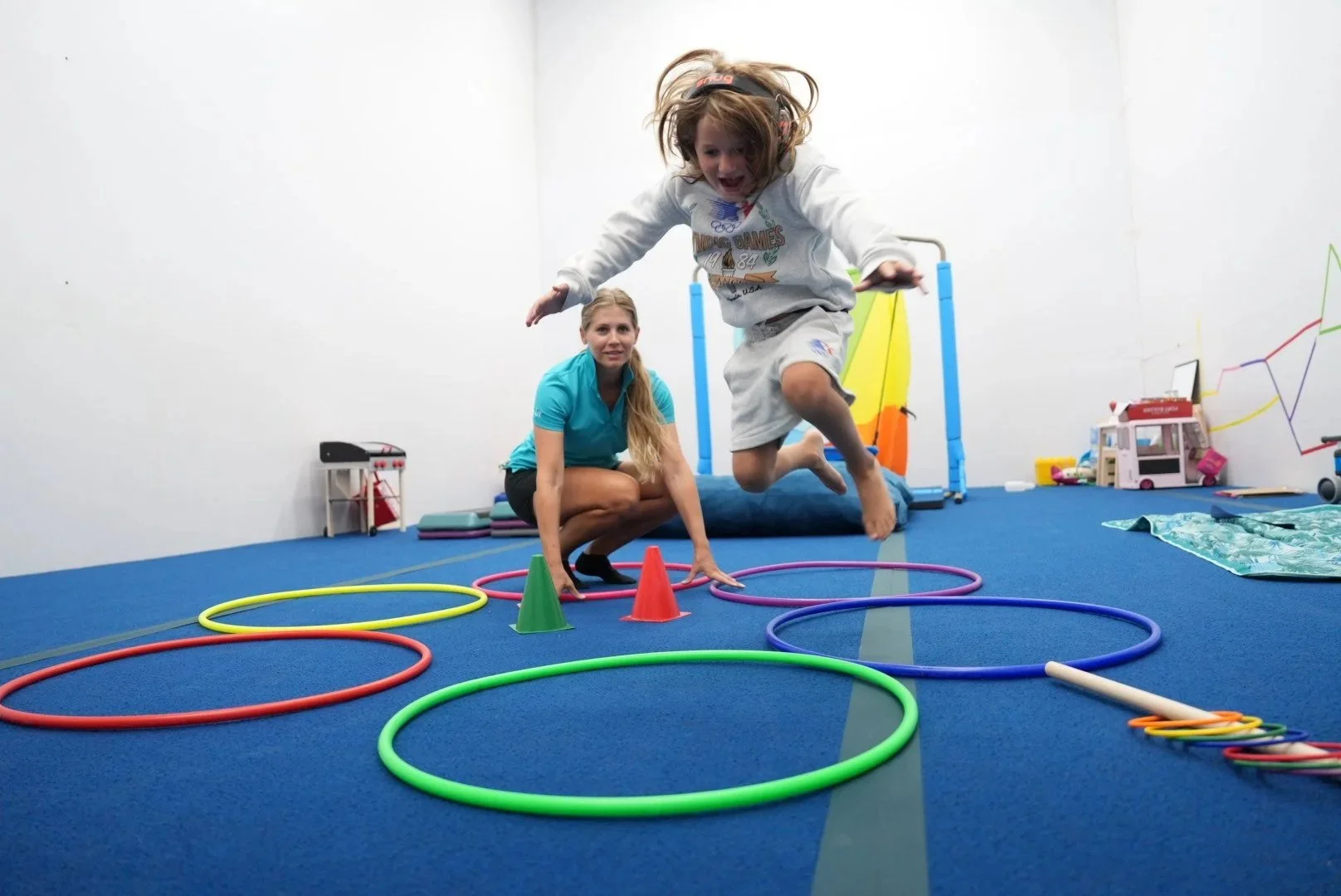Child practicing balance and motor planning with an occupational therapist at Apollo Beach Therapy Center.
