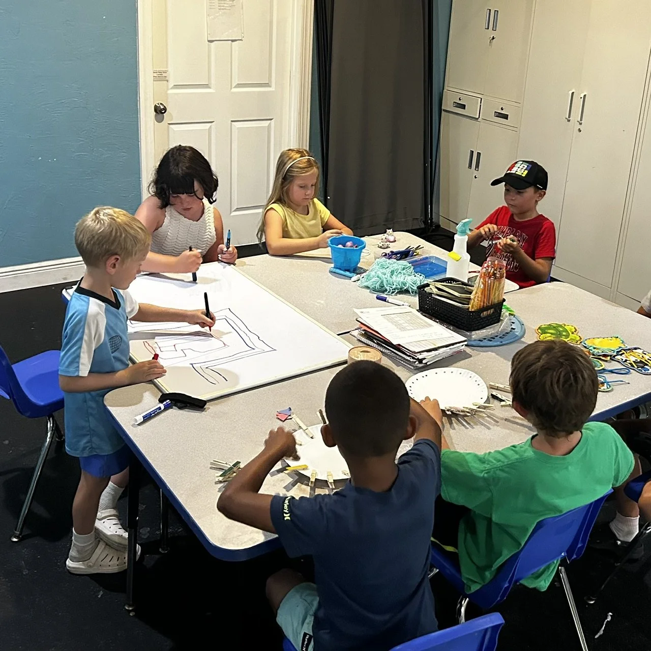 Children participating in a therapist-led handwriting and school skills group at Apollo Beach Therapy Center.