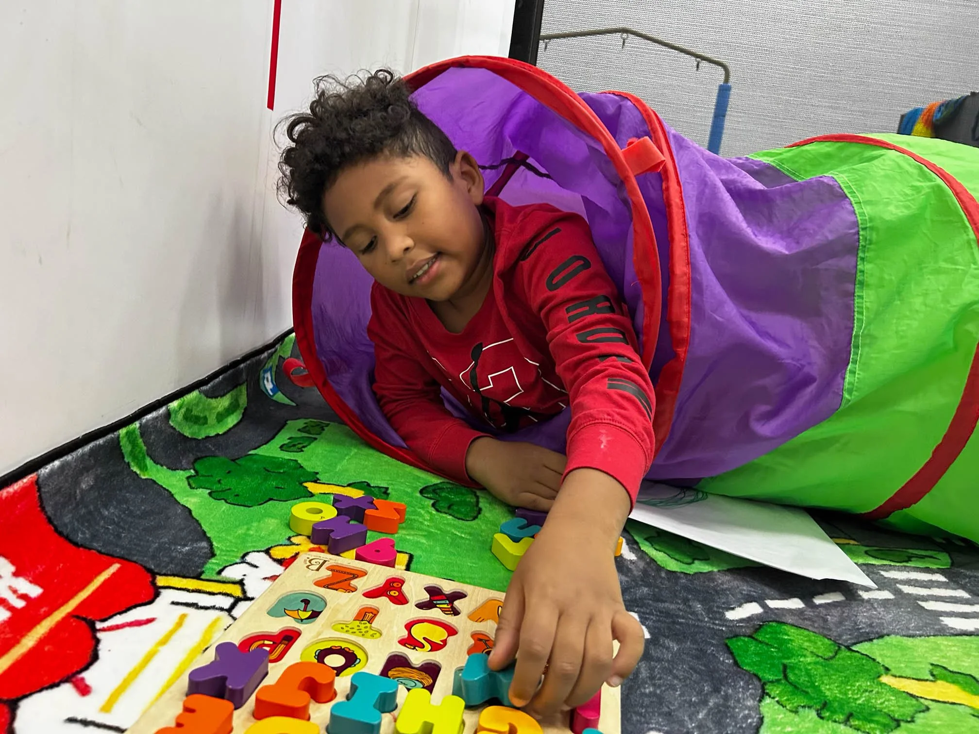 Child completing a hands-on task to support attention, planning, and executive functioning during occupational therapy.