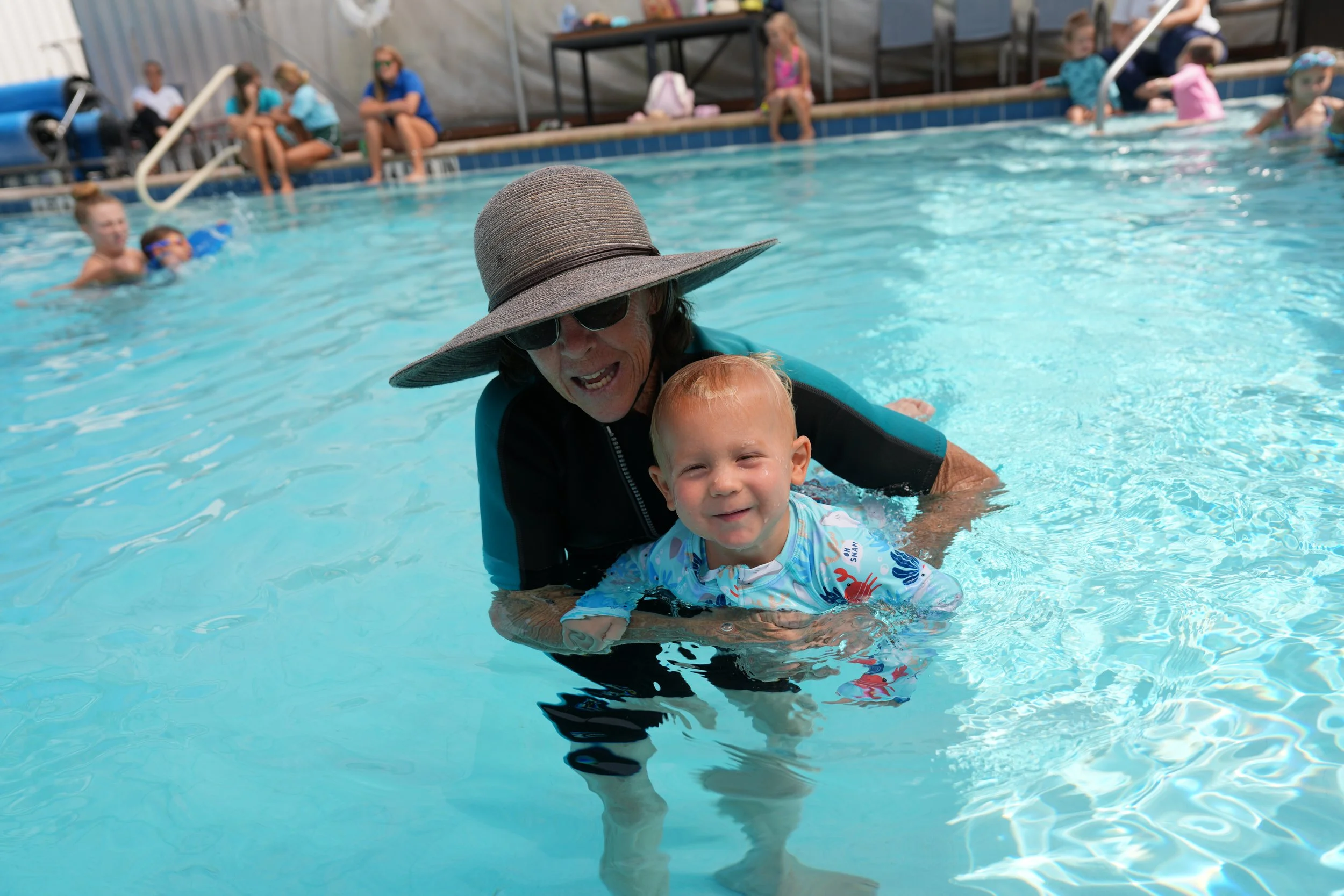 Young child participating in aquatic occupational therapy with therapist support at Apollo Beach Therapy Center.