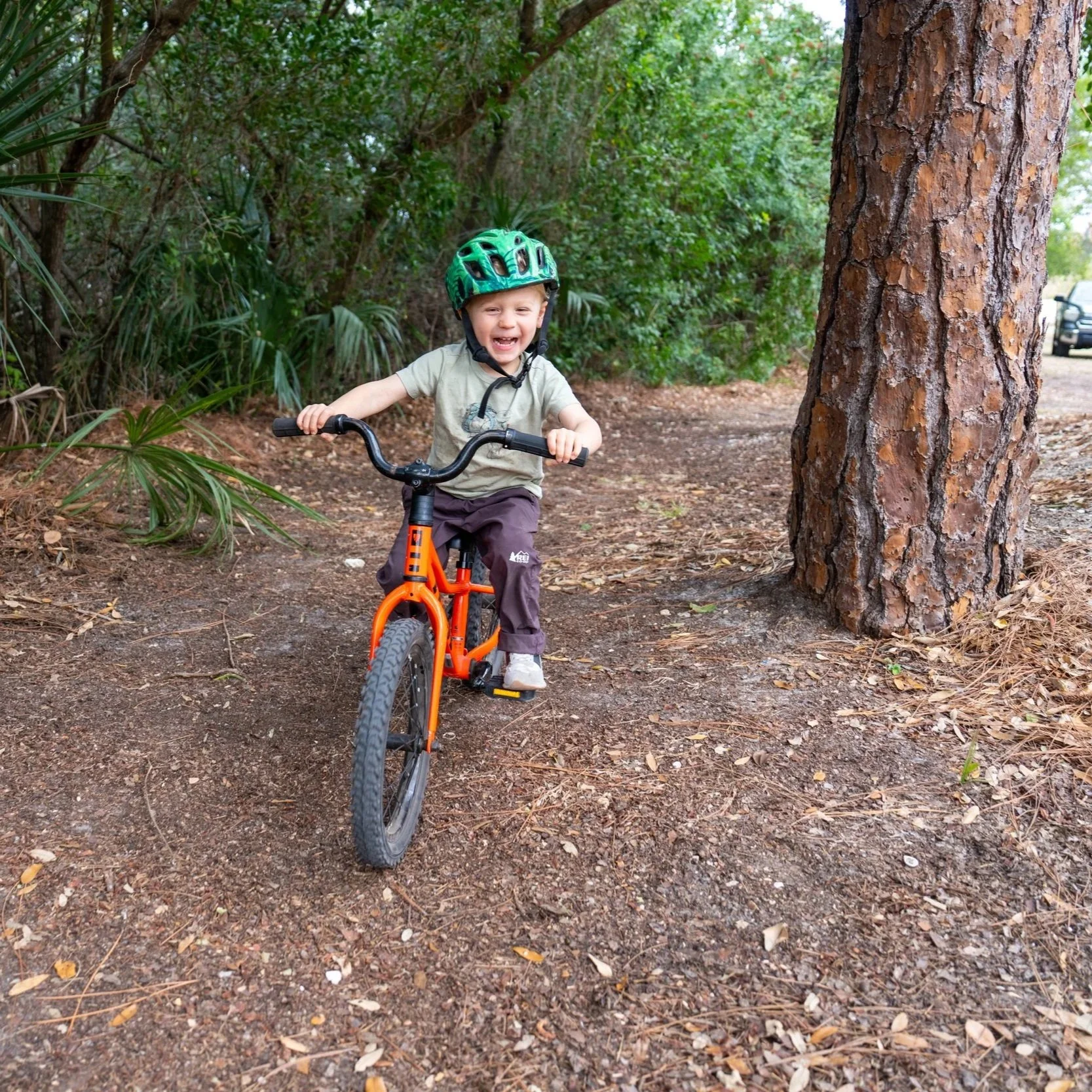 Child practicing balance, coordination, and bike-riding skills during occupational therapy at Apollo Beach Therapy Center.