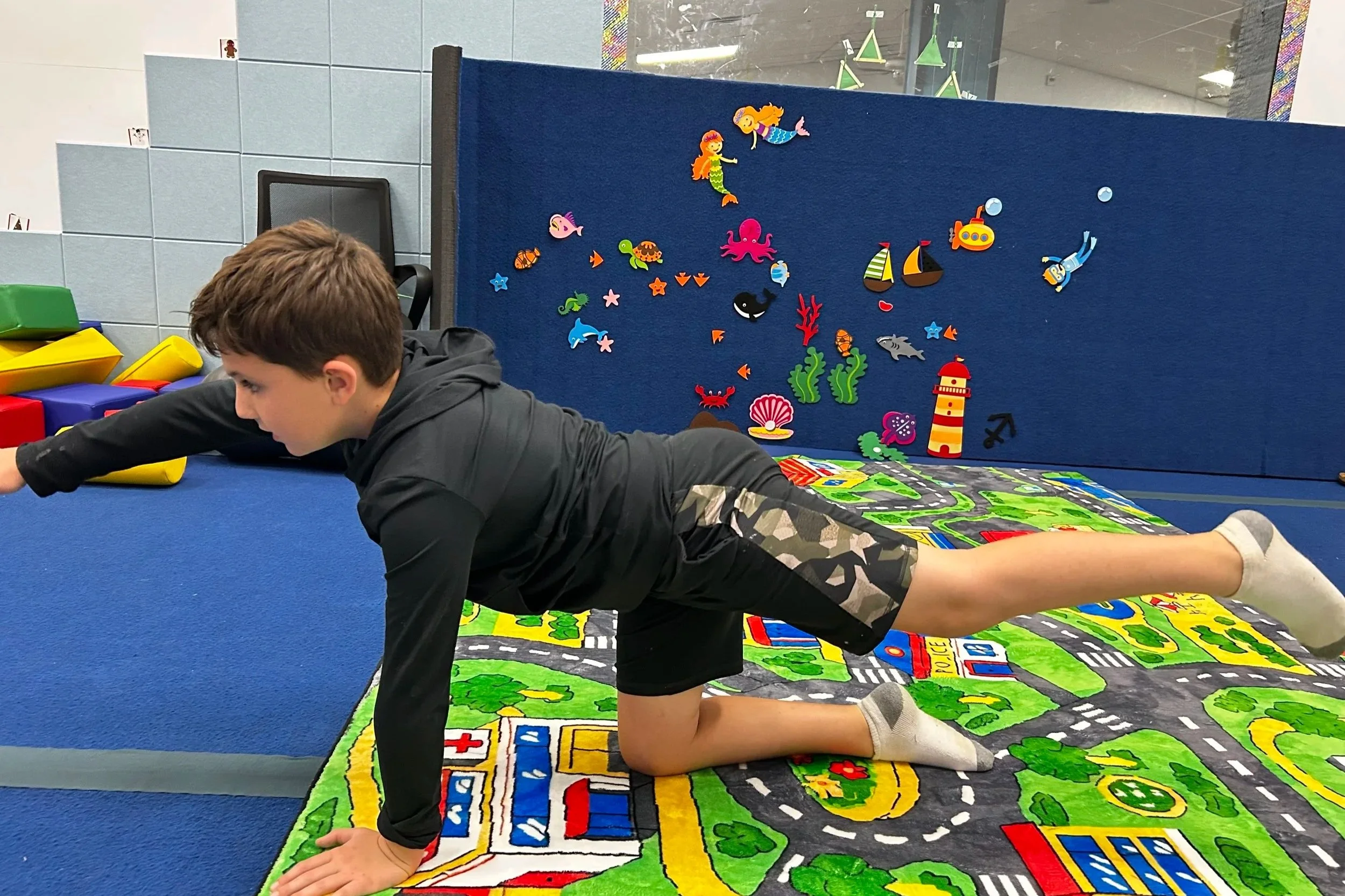 Child completing a movement exercise during primitive reflex occupational therapy at Apollo Beach Therapy Center.