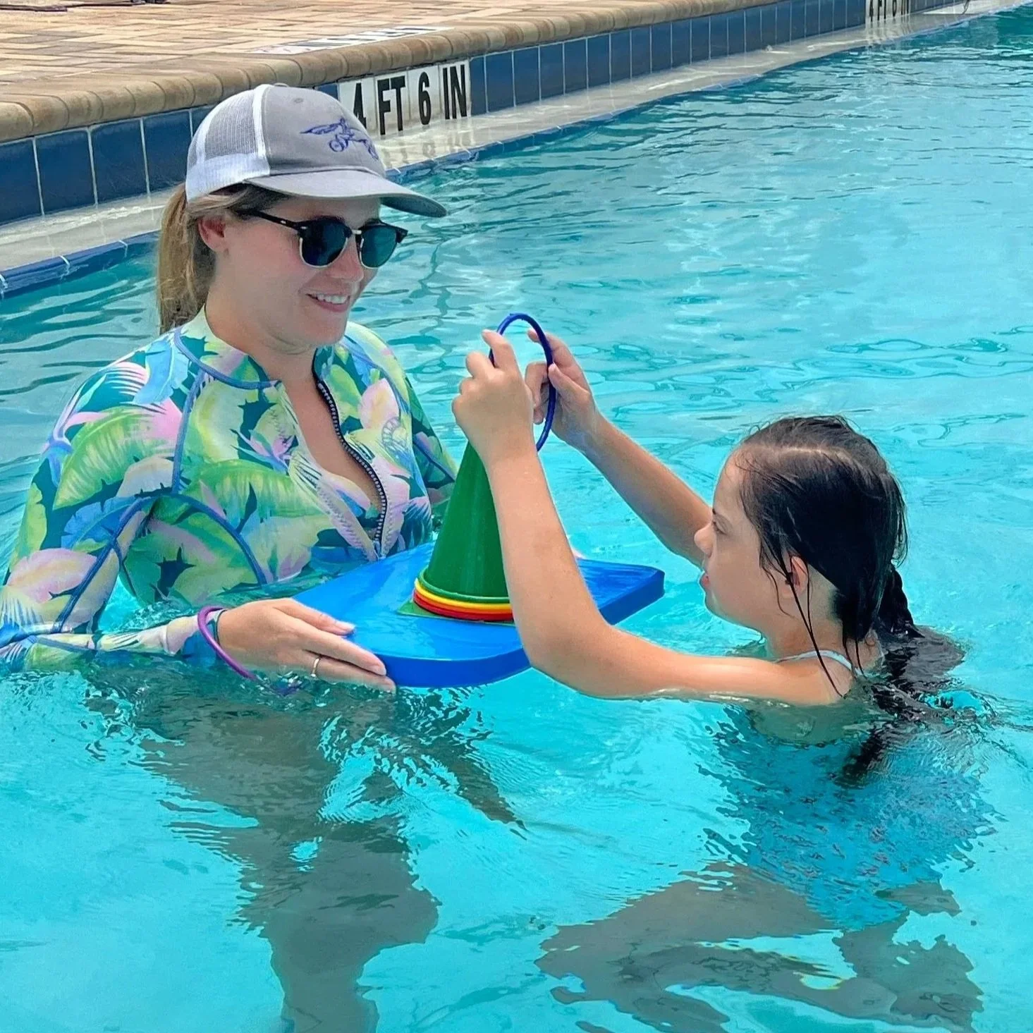 Child participating in pediatric aquatic therapy with an occupational therapist at Apollo Beach Therapy Center.