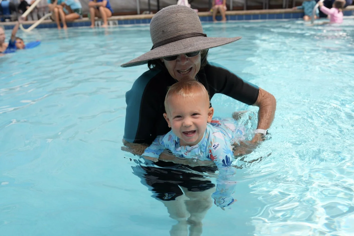 Young child participating in aquatic occupational therapy with a therapist at Apollo Beach Therapy Center.