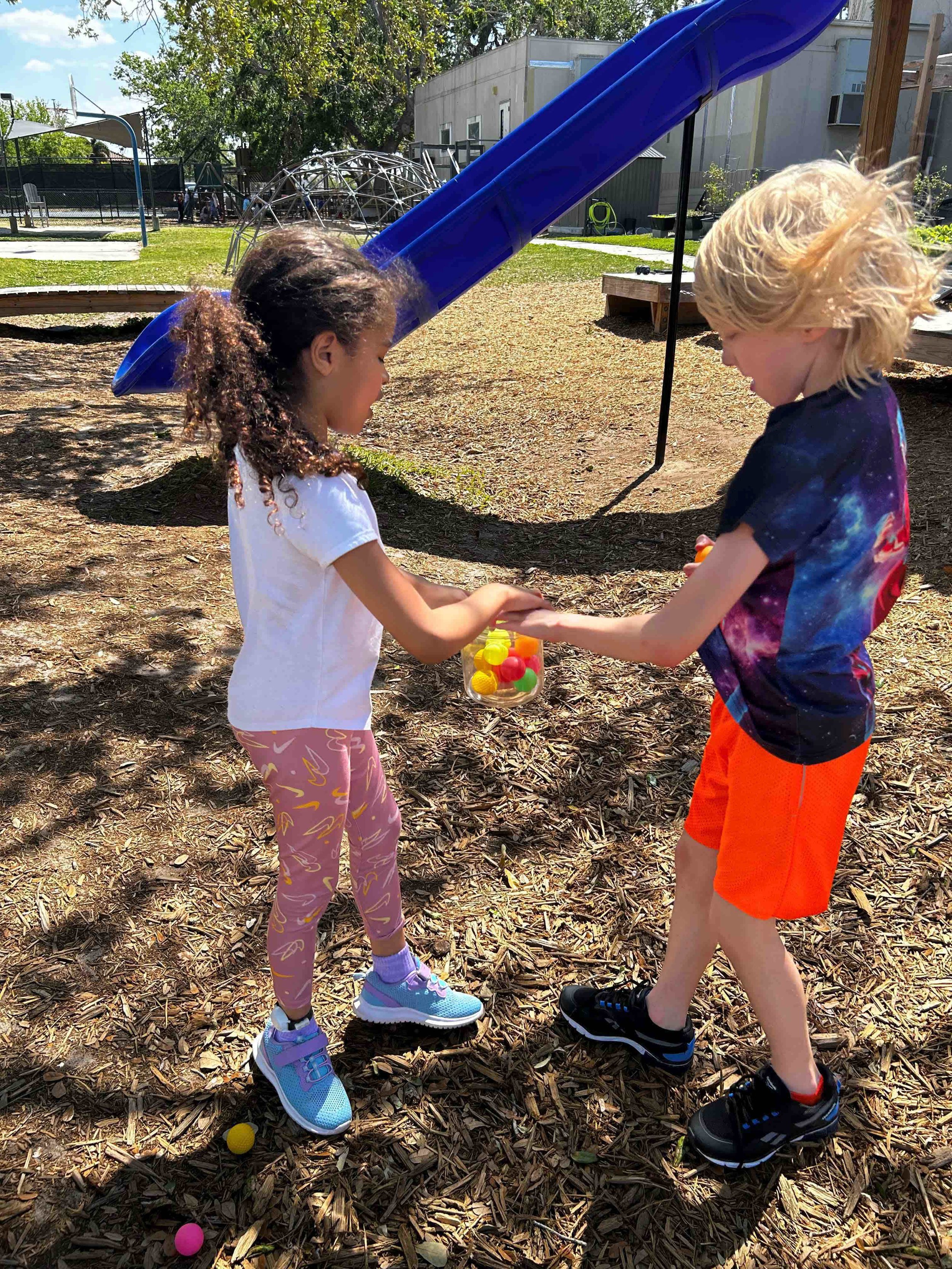 Children practicing turn-taking and peer interaction during an outdoor occupational therapy activity.
