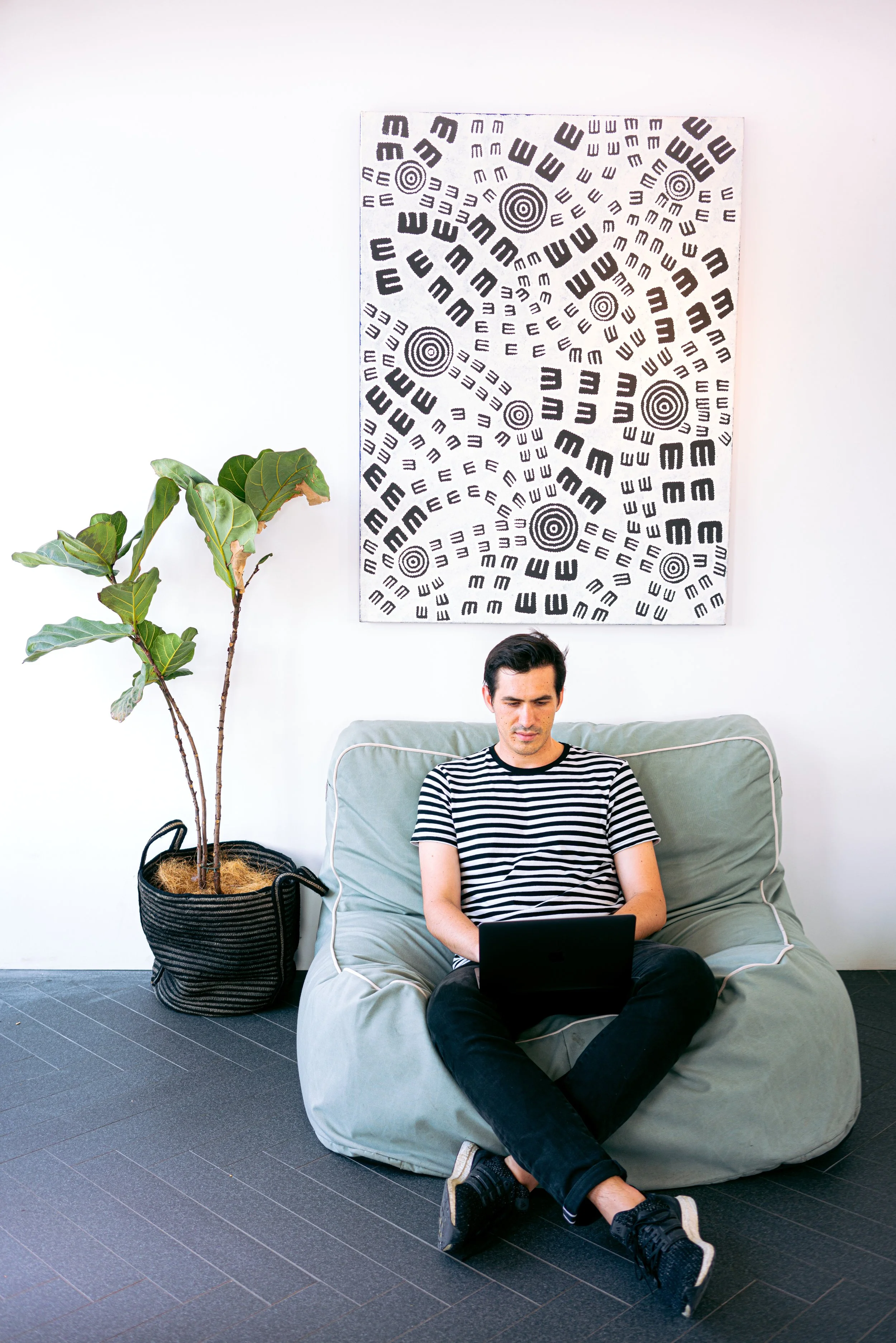 Man working on laptop while sitting on couch