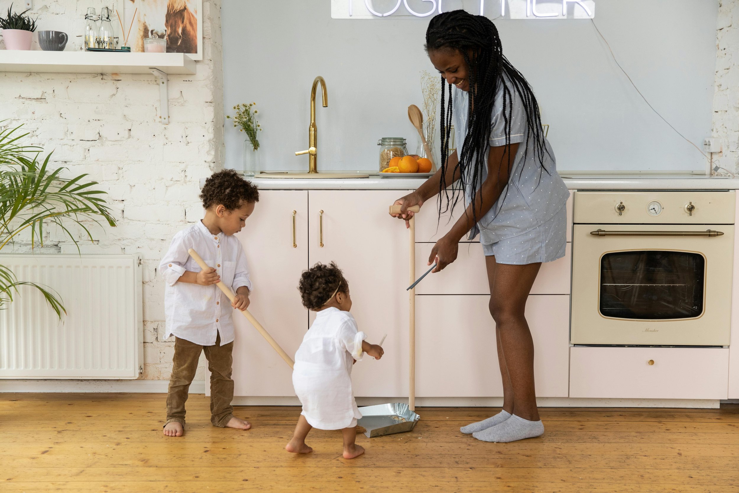A family cleaning up a kitchen together