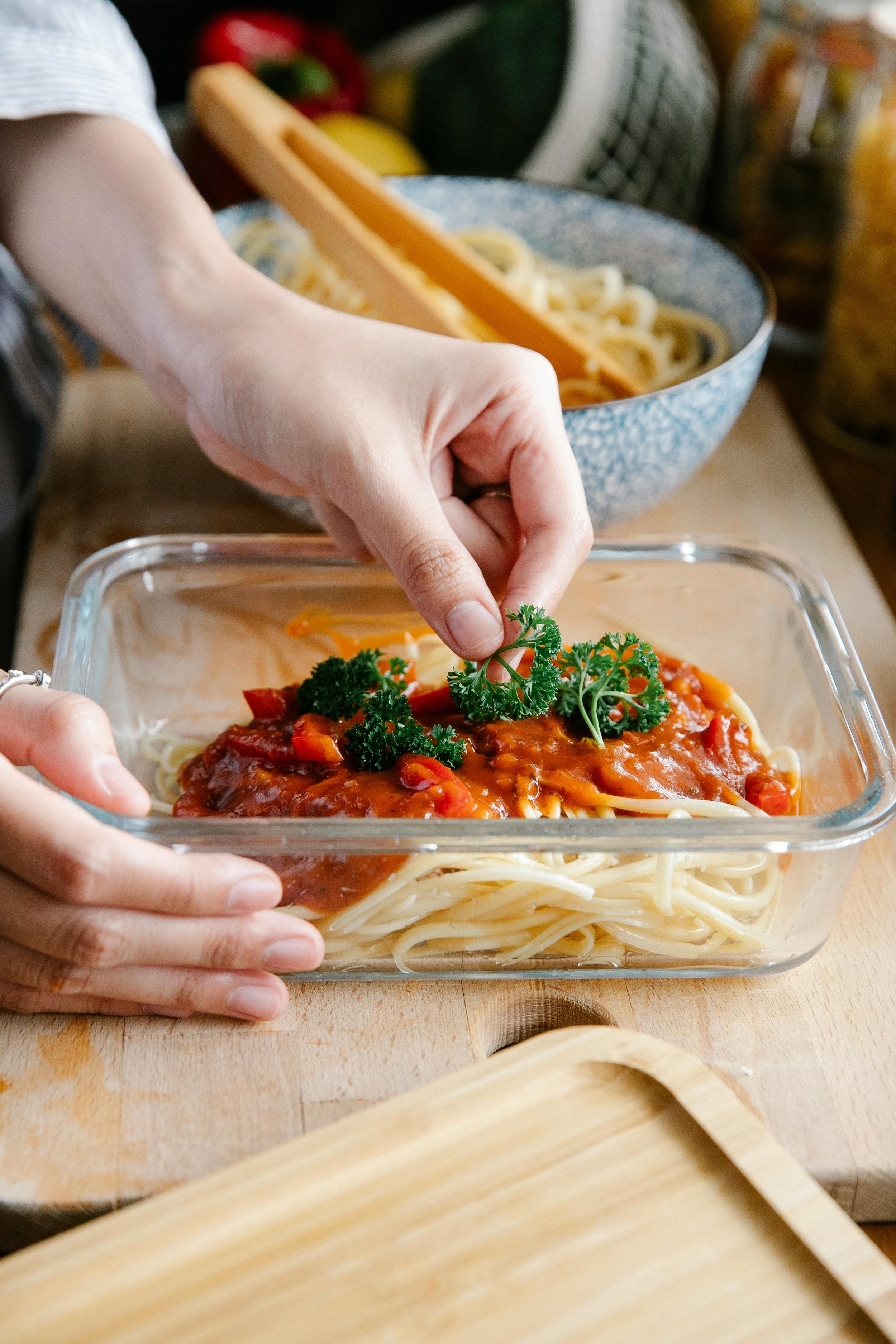 Woman storing her food in a glass container