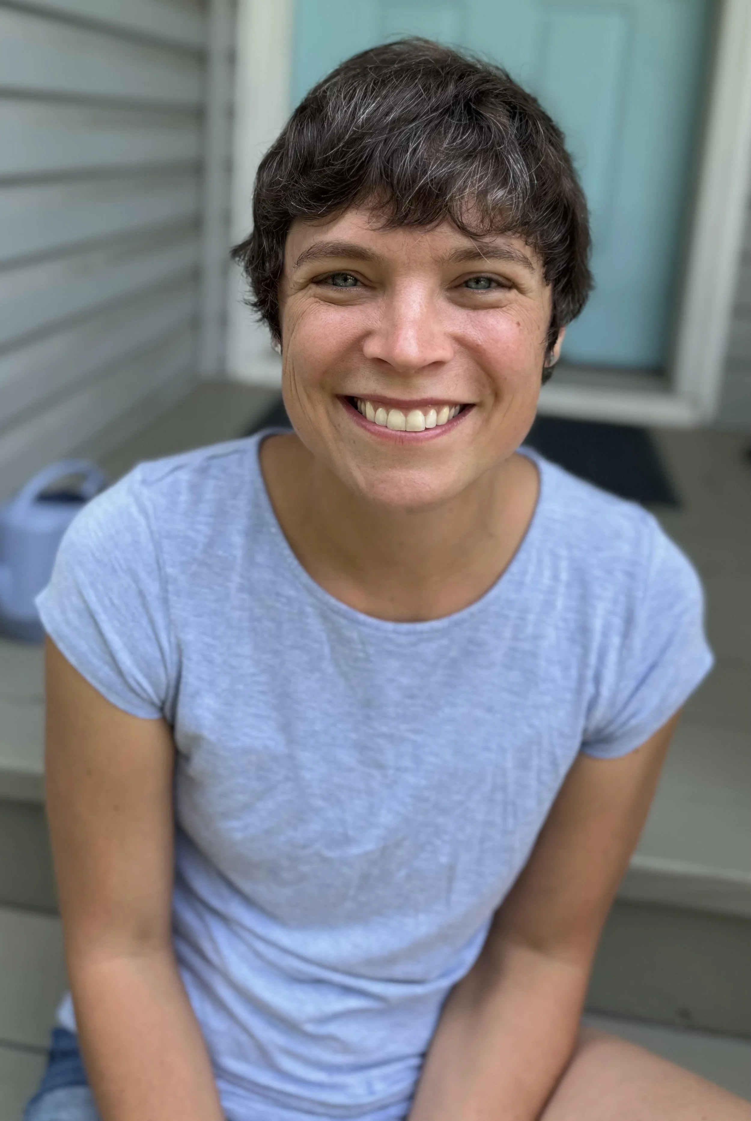 Photograph of your woman sitting on steps. Ryan Babarsky poet and singer