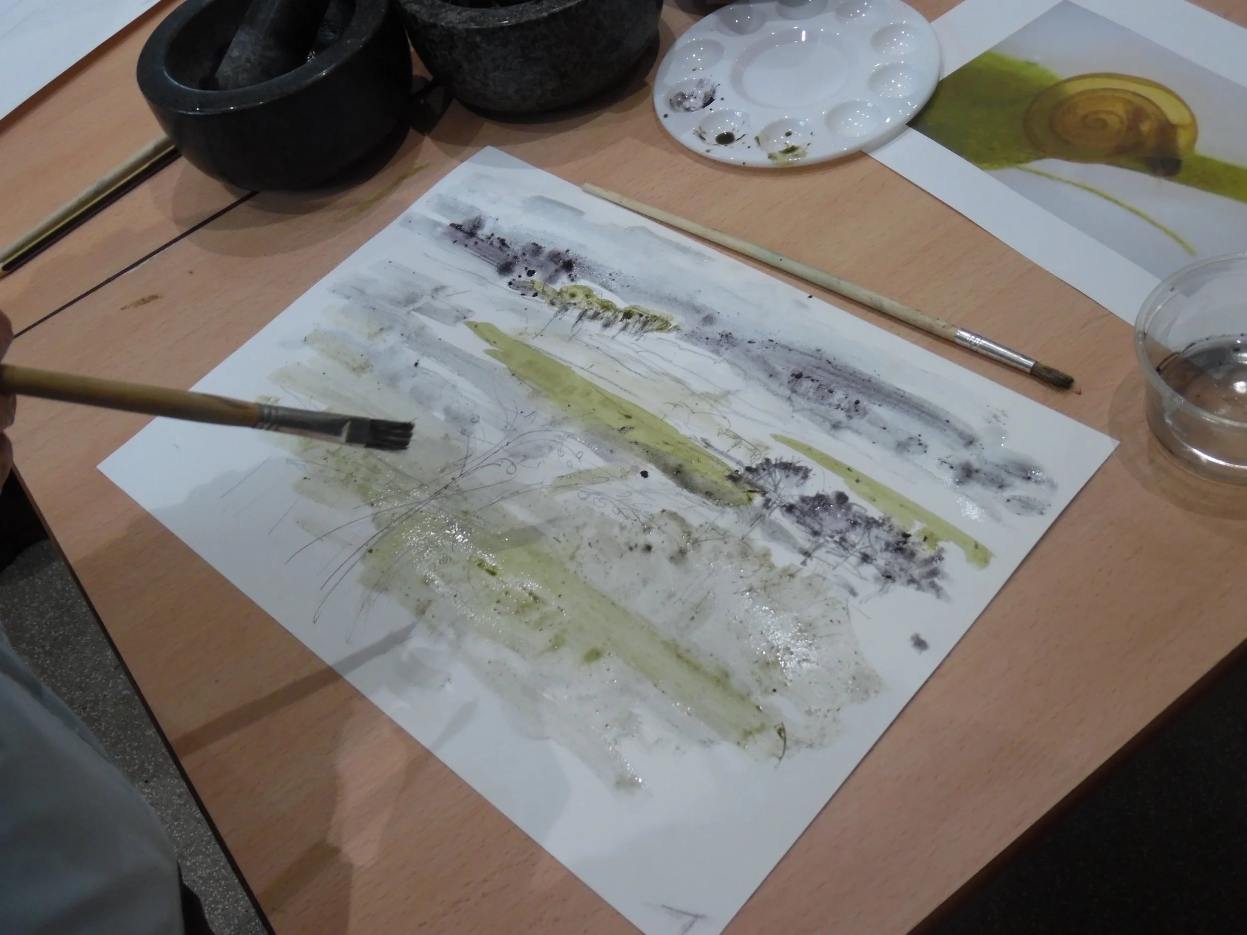 Adult participant painting with natural inks we created from collected materials at Pulborough Brooks Nature Reserve
