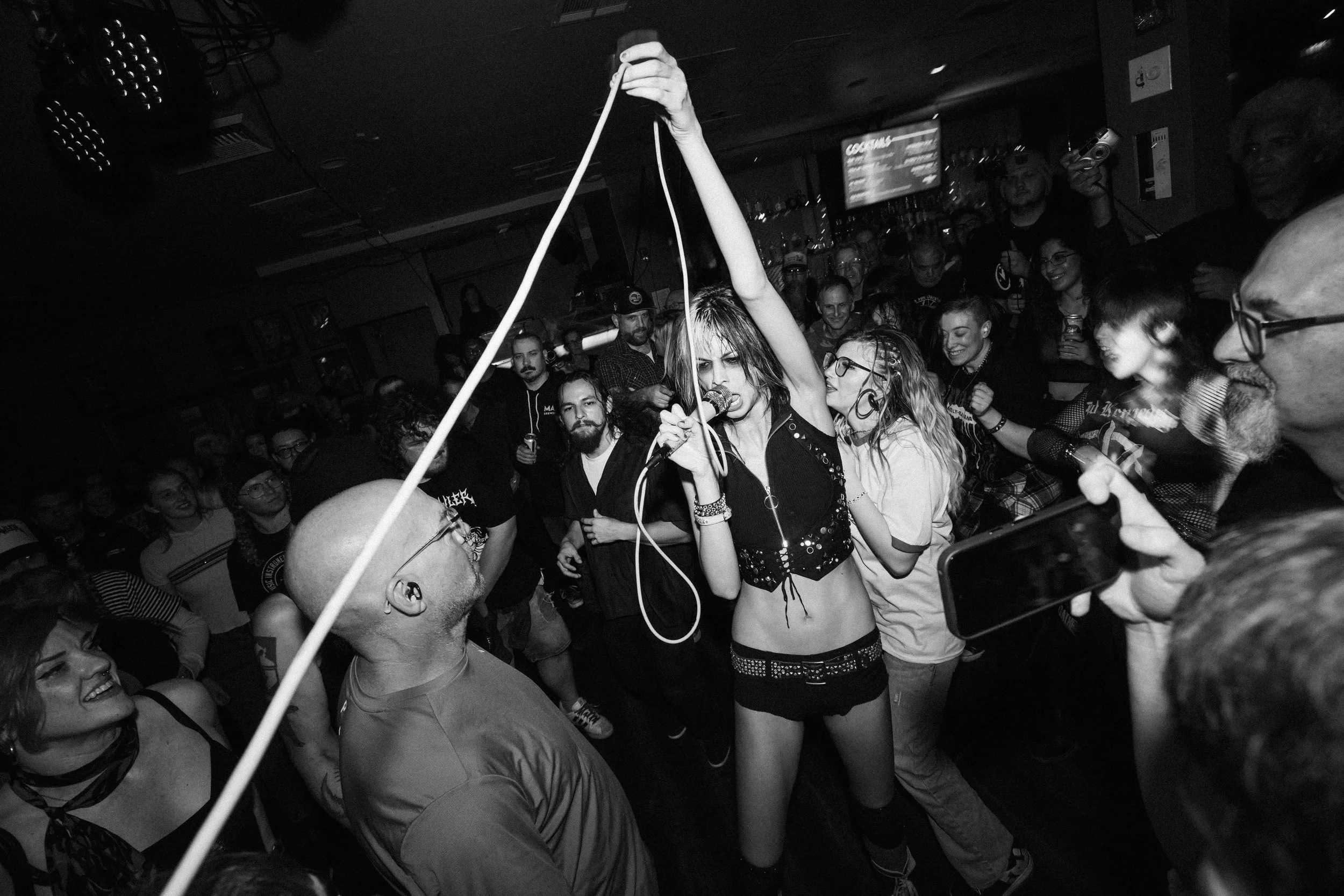Flash photography of Arrow de Wilde, lead singer of Starcrawler, roaming in the crowd at a concert in Harlow's Starlite Room Sacramento CA — by local music Photographer Nicole Sepulveda