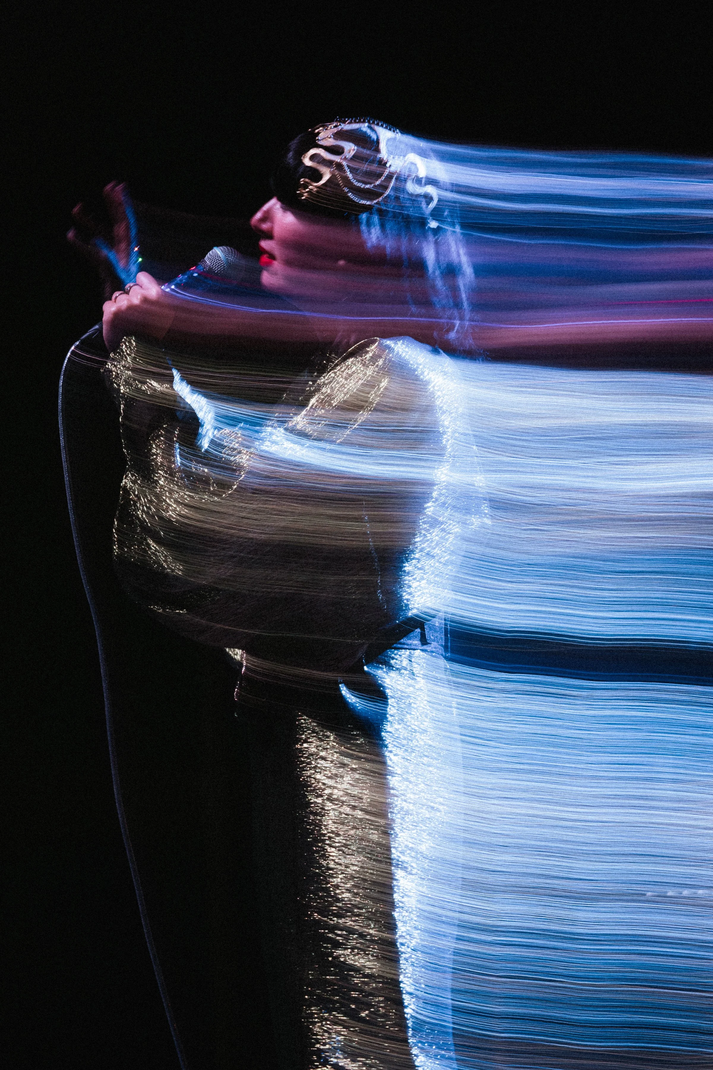 Blurry long exposure light trail shot of Karen O, lead singer of the Yeah Yeah Yeahs, at the Davies Symphony Hall in San Francisco CA 7/15/2025 Hidden in Pieces tour — by San Sacramento Concert Photographer Nicole Sepulveda