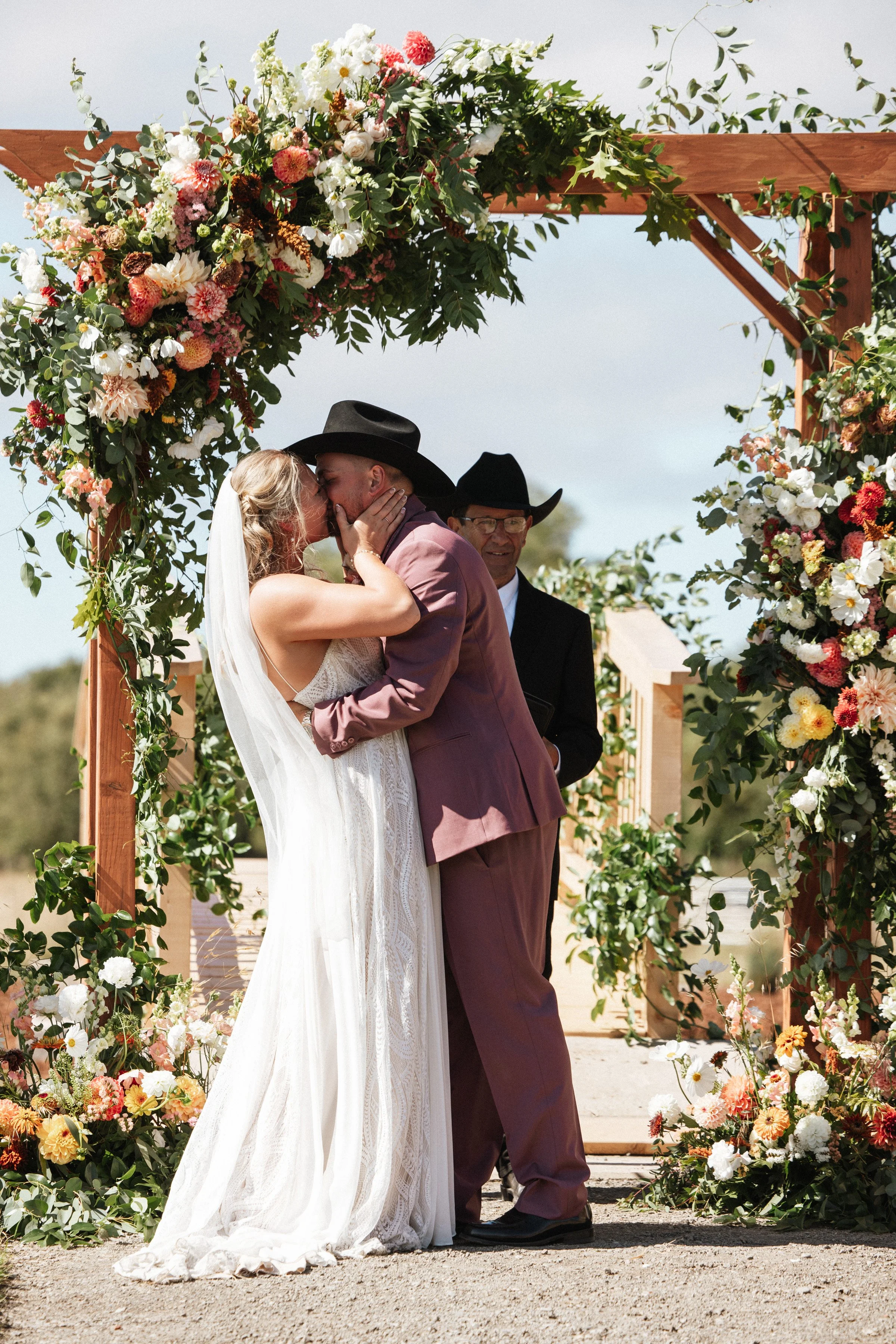 First kiss wedding ceremony outdoors summer bright sun