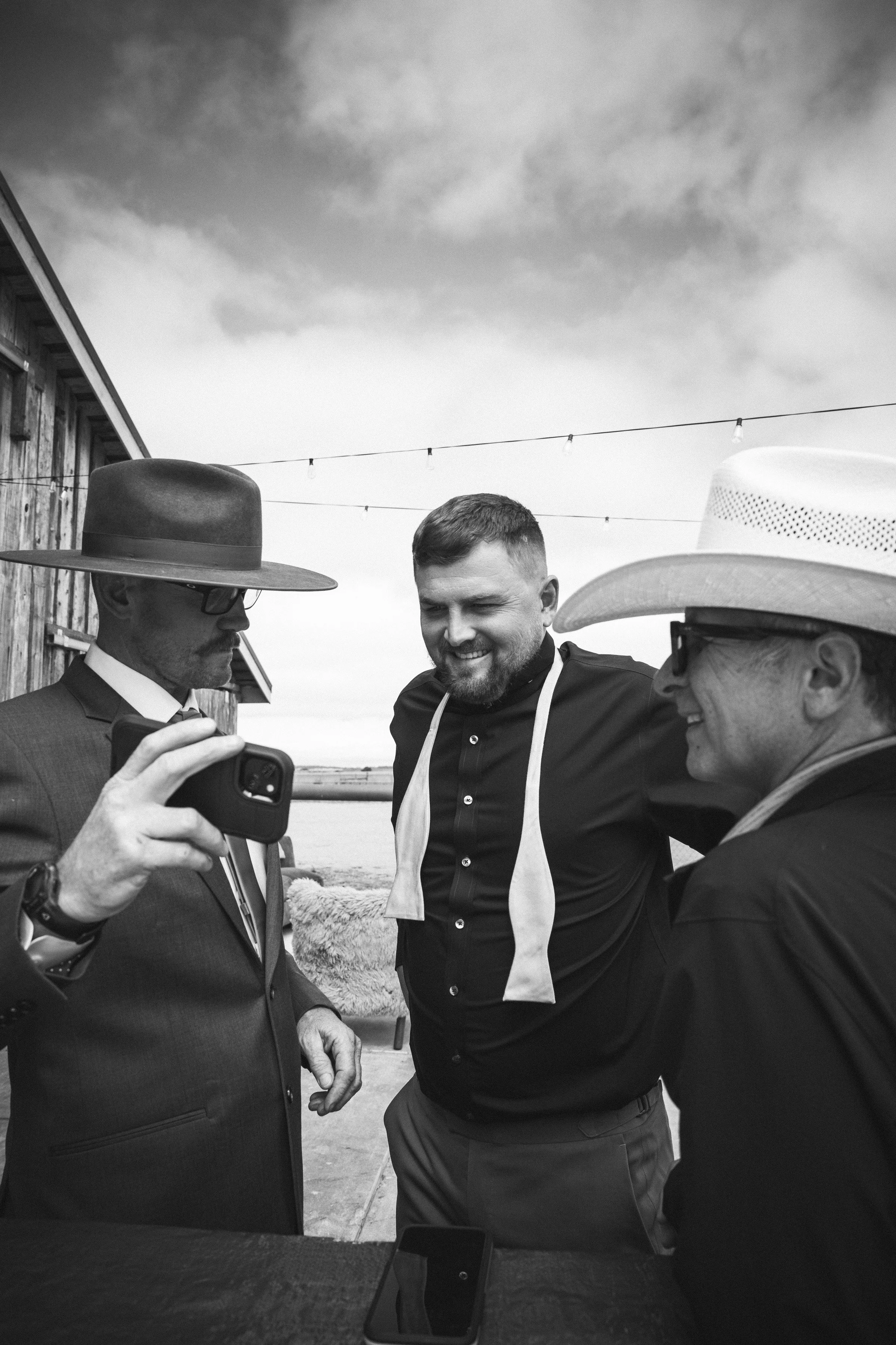 Groom black and white getting ready with dads