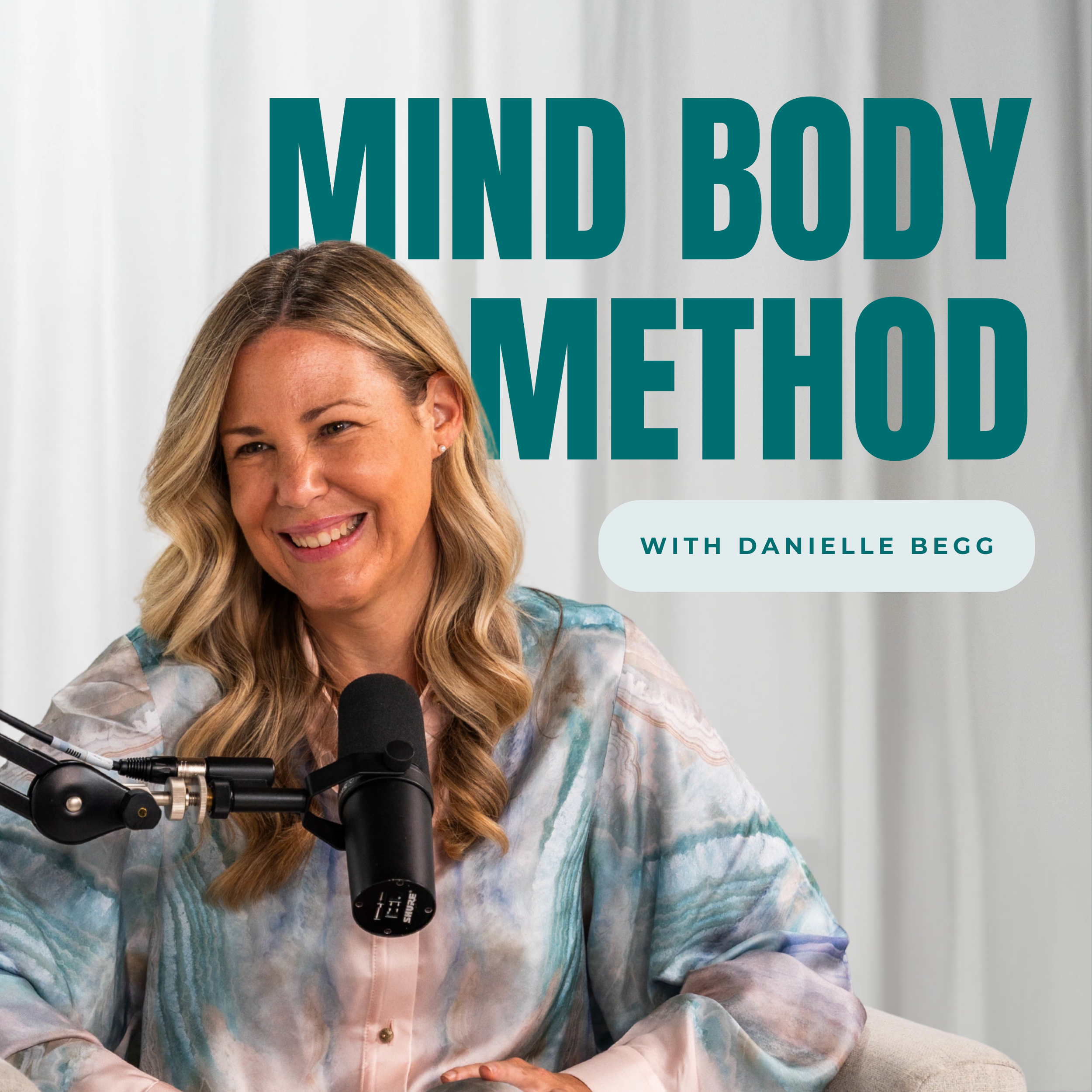 A woman with blonde hair smiling while speaking into a microphone, with the text 'Mind Body Method with Danielle Begg' in the background.