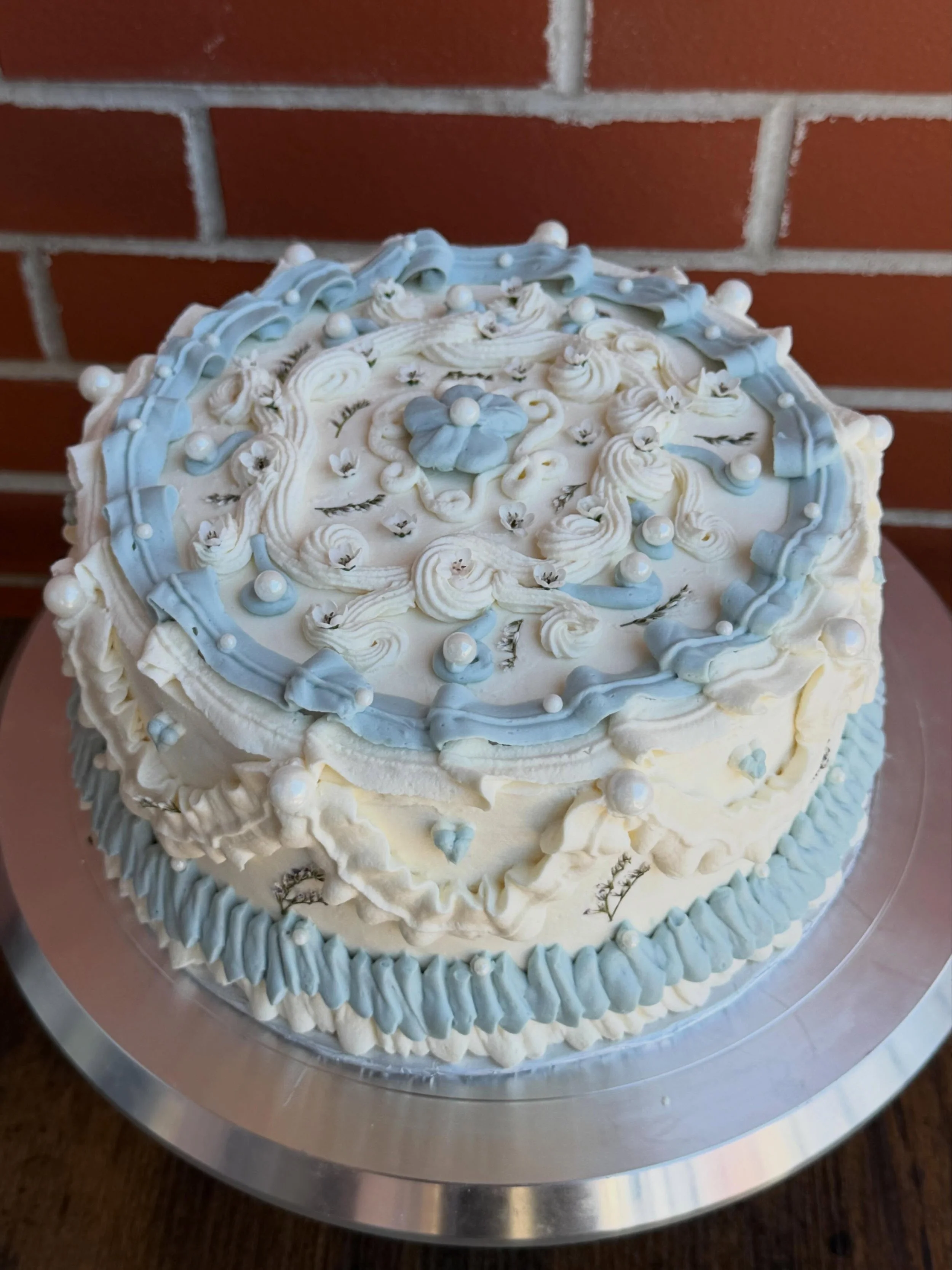 wedding cake for emily &amp; joseph 🩵

chocolate cake, raspberry jam, vanilla bean buttercream