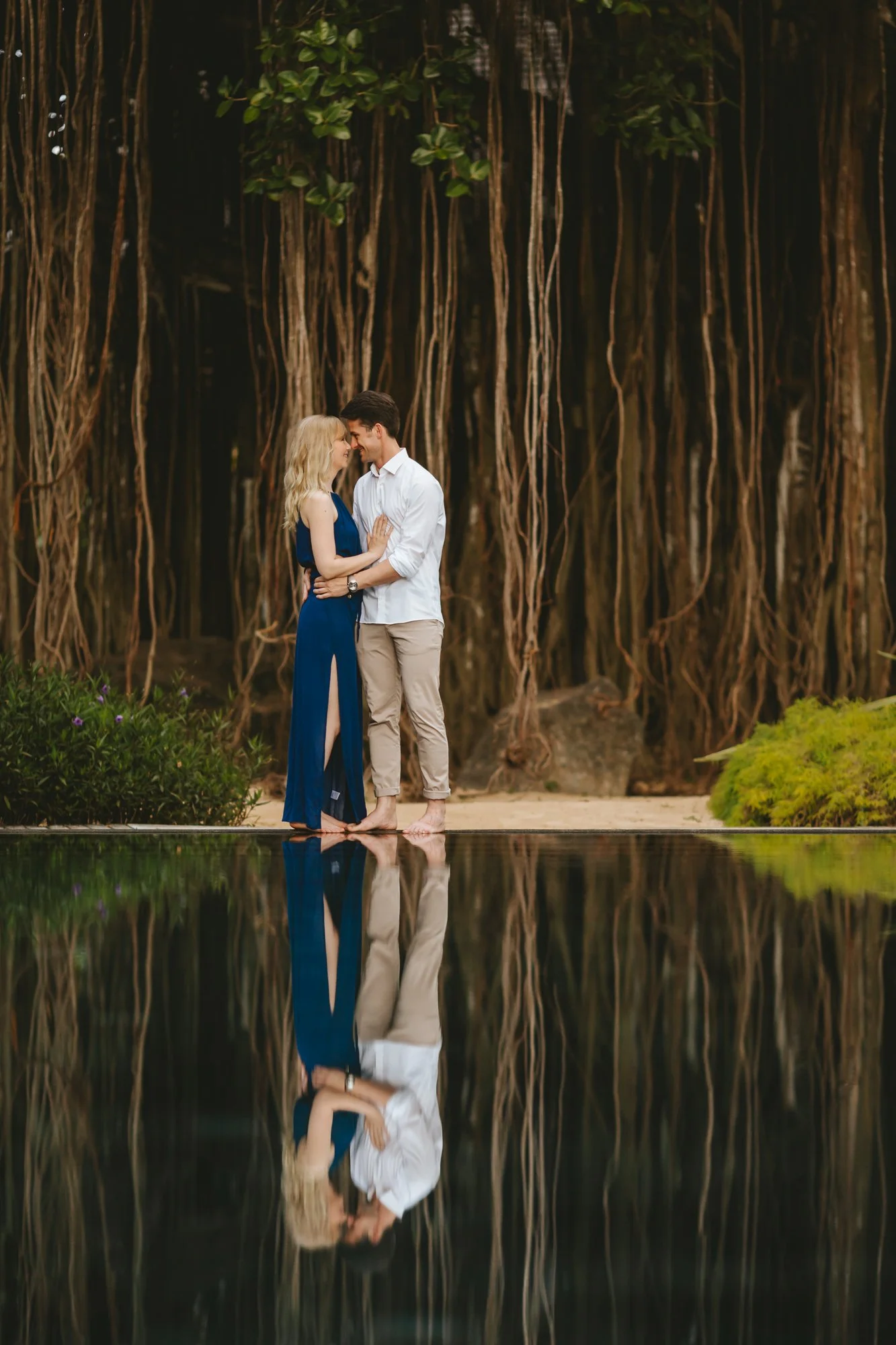 Mauritius destination wedding couple photographed beside a tropical reflection pool
