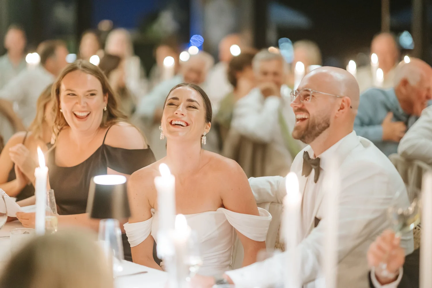 Bride and groom laughing with guests at a Cape Winelands wedding reception