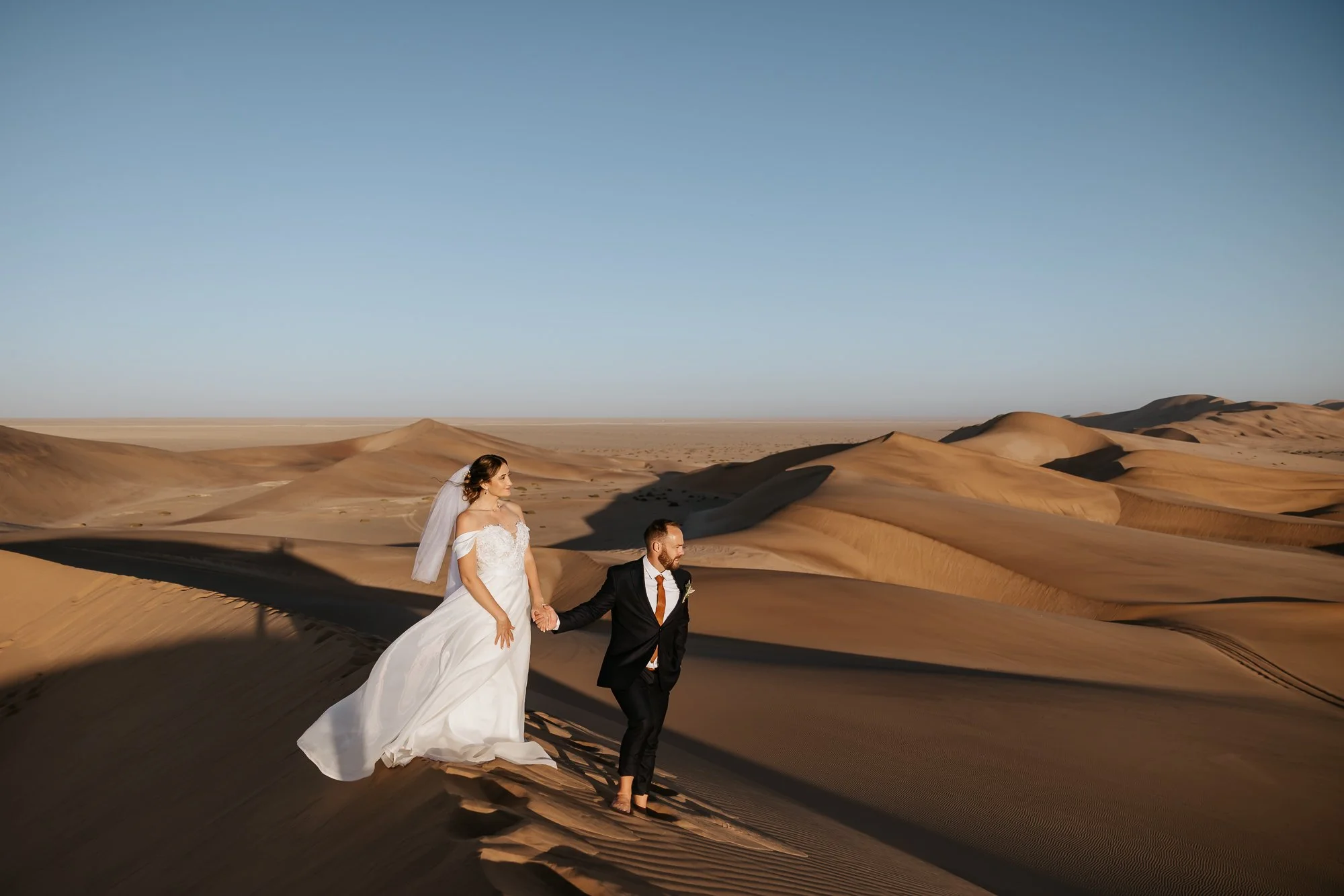 Bride and groom standing on the Nambian dunes on the East Cost of the Namib desert