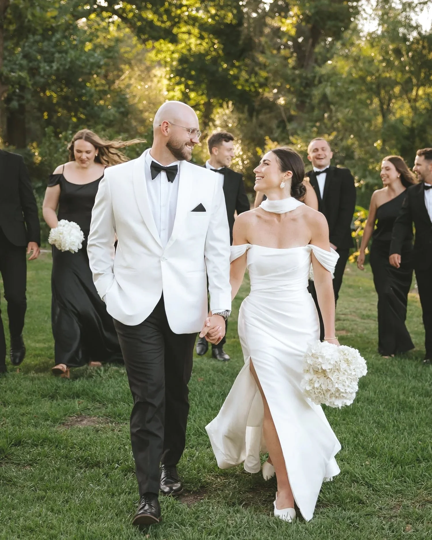Bride and groom walking with their wedding party in the Cape Winelands