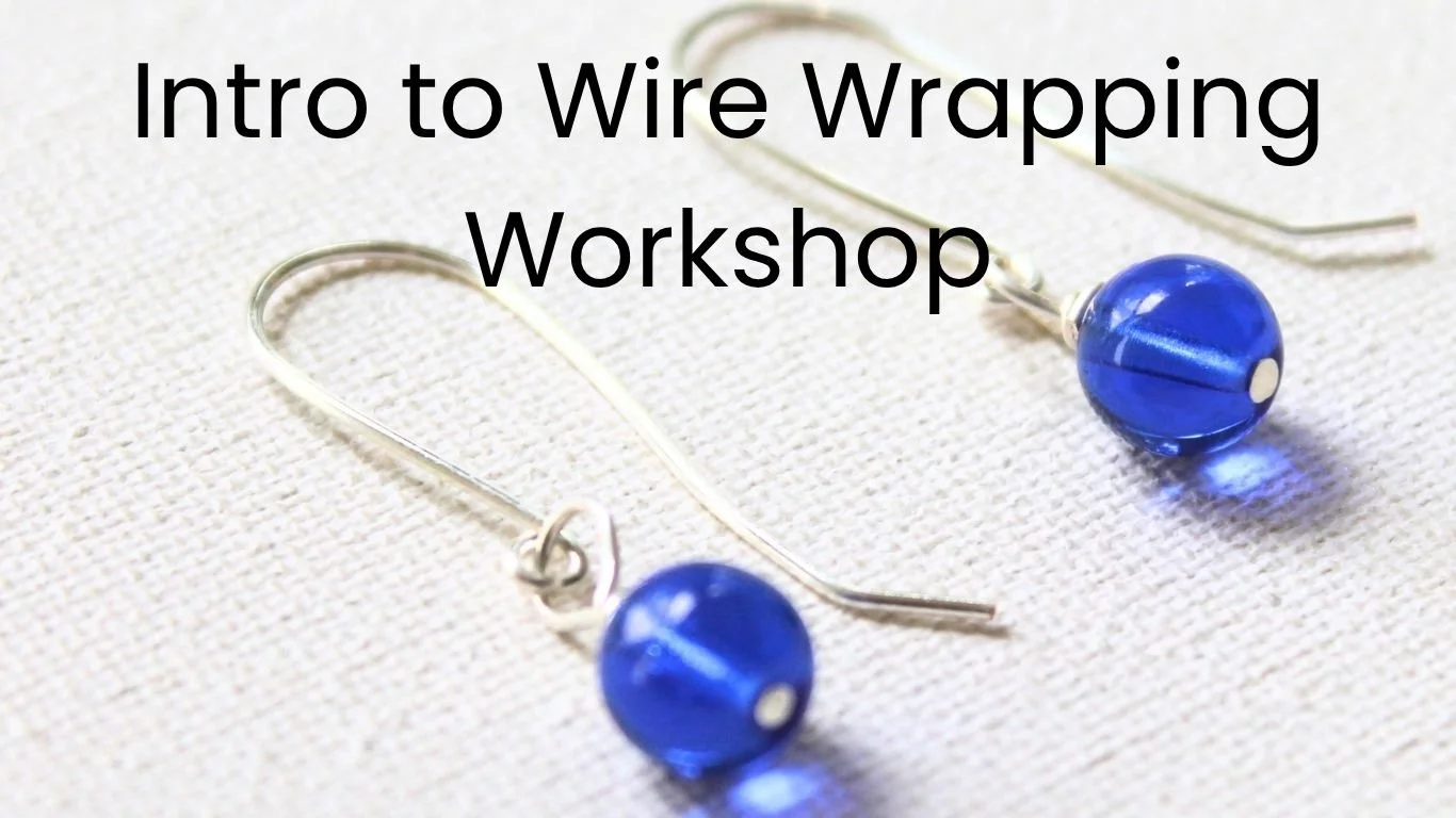 Pair of earrings with blue glass beads dangling from silver ear hooks, words Intro to Wire Wrapping Workshop is overlaid.
