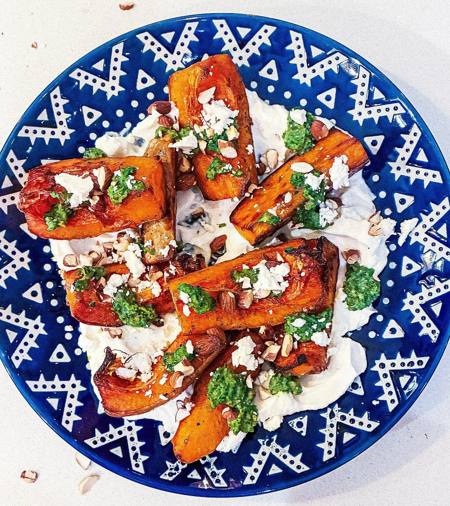 Roasted butternut squash with almond pesto and crumbled feta, served with salted yogurt and toasted almonds. 

Chunk up the squash (no need to peel, thankfully) and roast till happily turning brown at the edges. Bung some skin-on almonds in the oven 