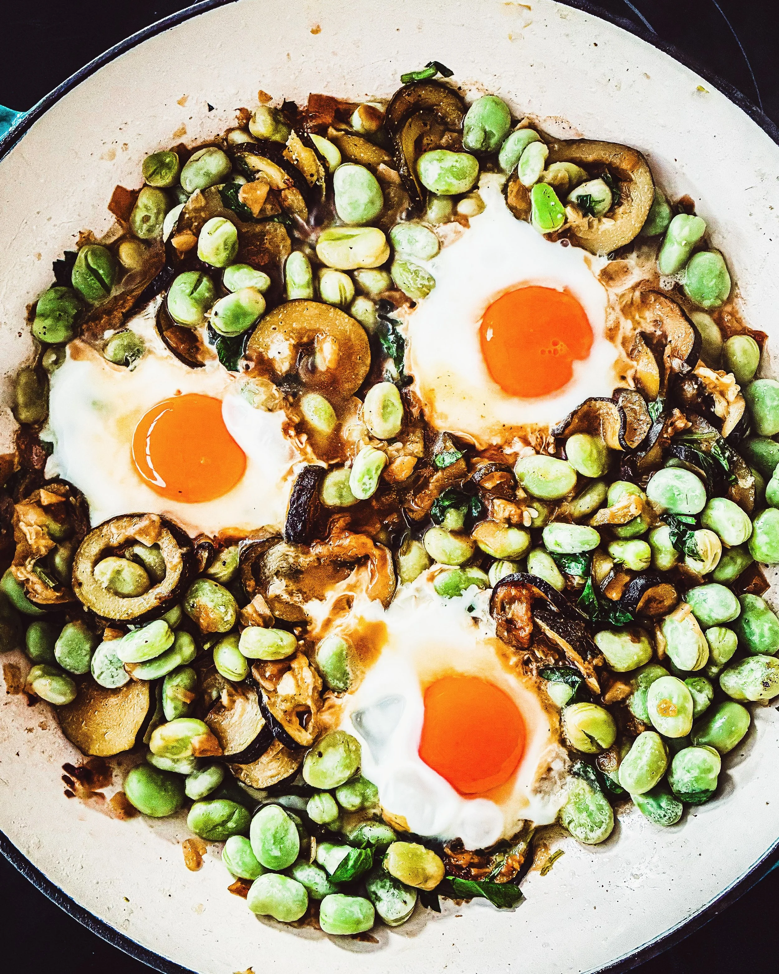 This is a great dish for a crappy, wet week: cosy, rosy eggs in an optimistically-seasonal bed of courgettes, broad beans, heaps of soft herbs and lots of garlic. 

Summer-ish shashuka from the smashing @honeyandco Daily cookbook.

Delicious whatever